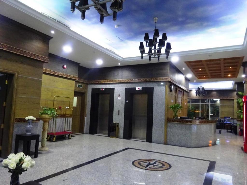 a lobby of a hotel with a chandelier at Alzebara 2 Apartment in Manama +21 photos
