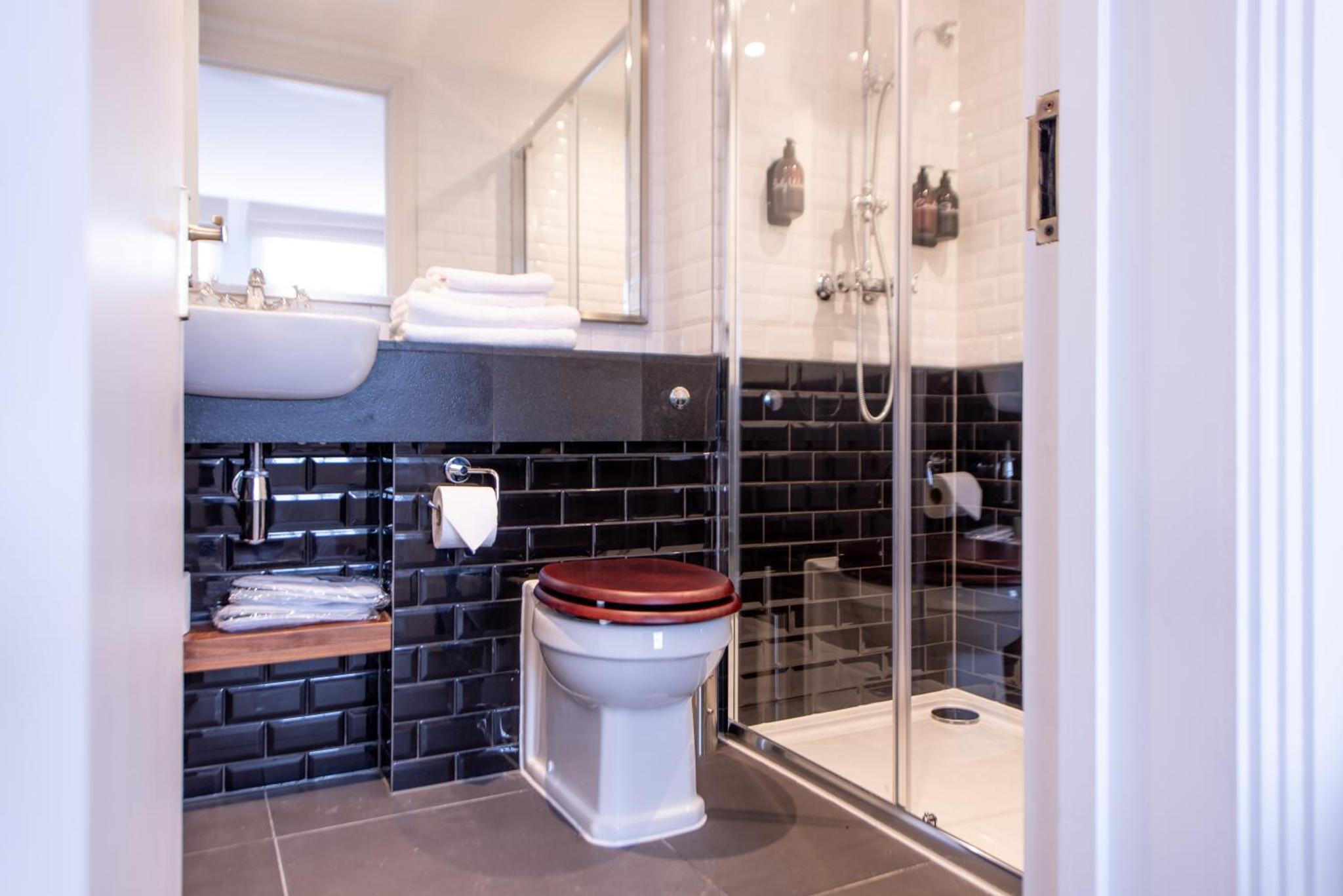 a bathroom with a toilet and a sink and a shower at Gunmakers in London +22 photos