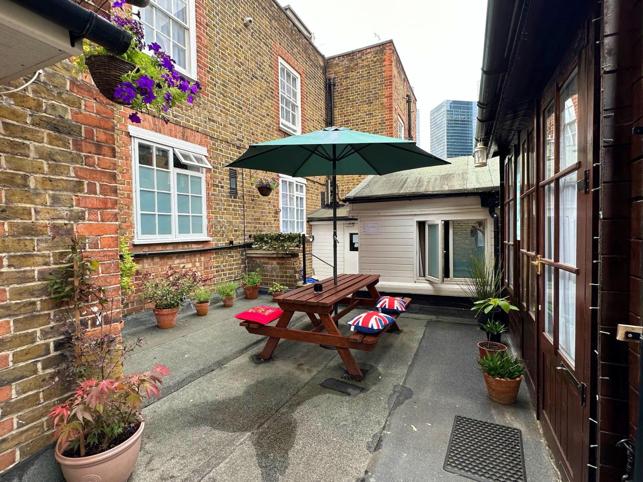 a patio with a picnic table and an umbrella at Monopoly in London