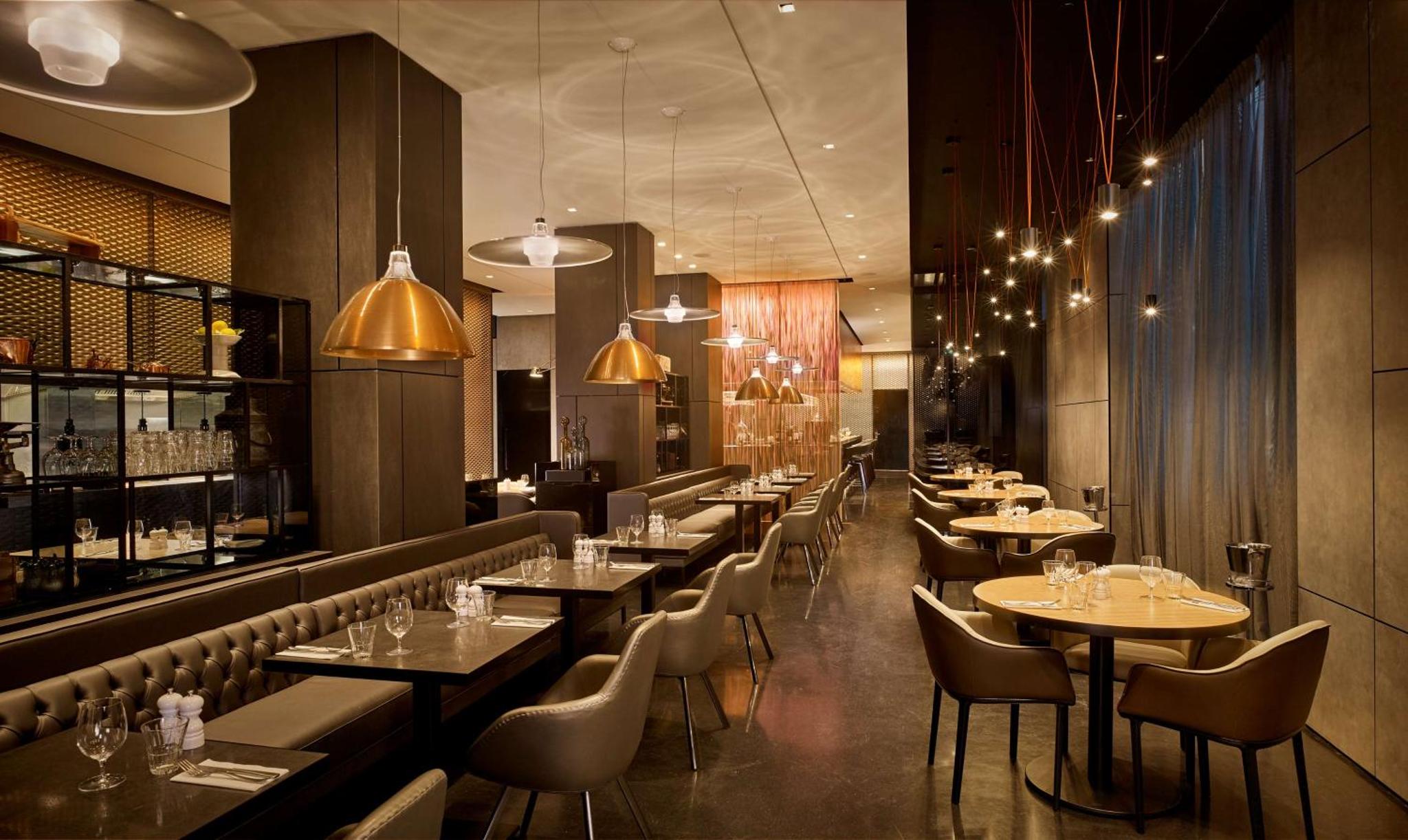 a restaurant with tables and chairs and a bar at Park Plaza London Waterloo in London