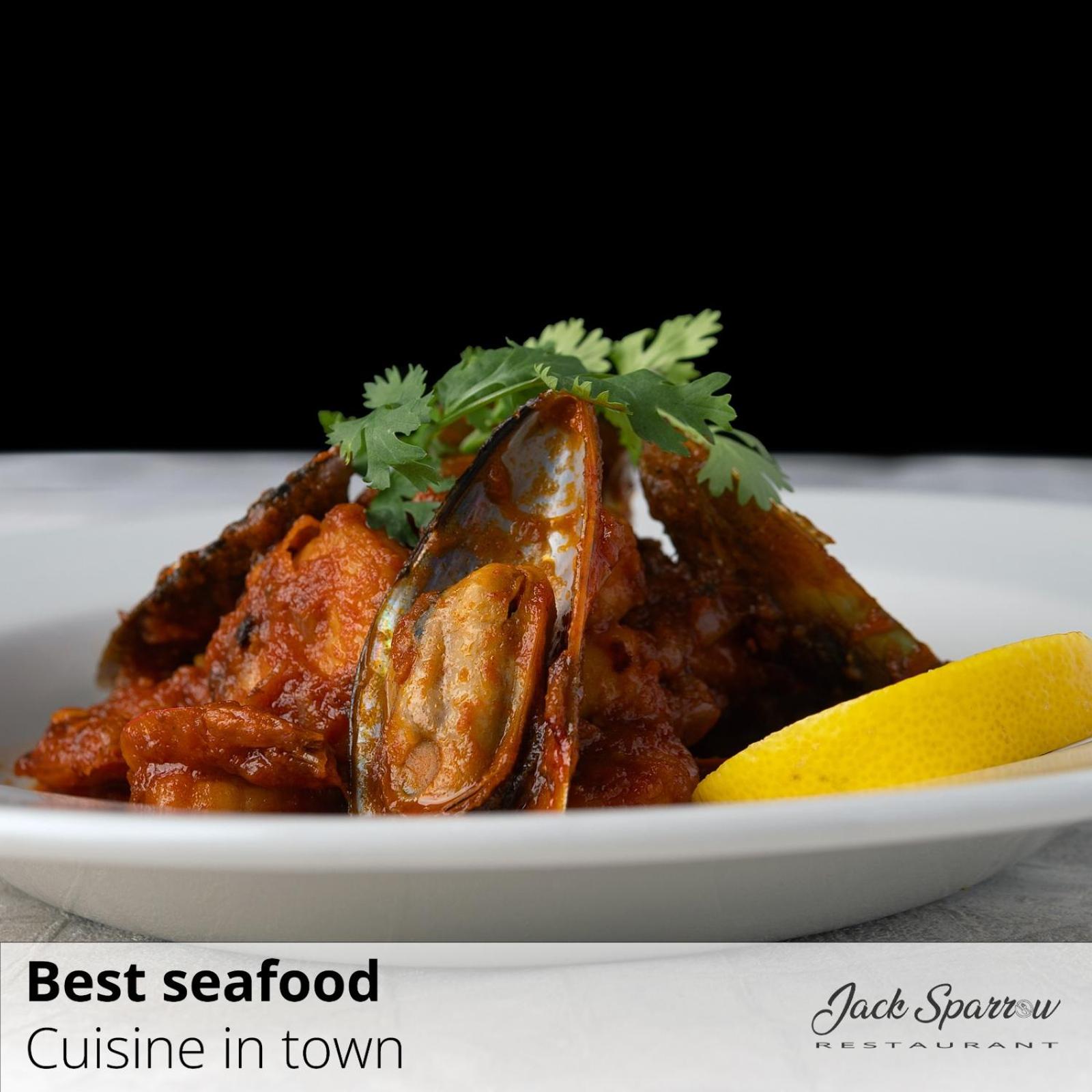 a plate of food with chicken and a lemon at Majestic Hotel in Manama