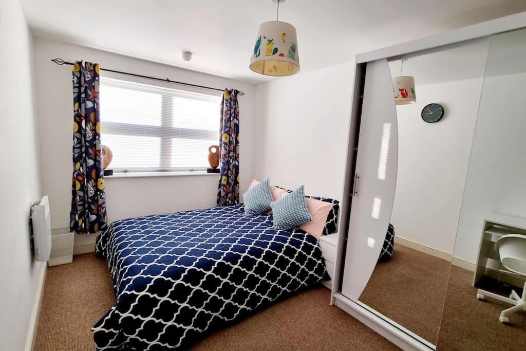 a bedroom with a bed and a large mirror at Entire Home in East London E3 near Bromley By Bow Station in London