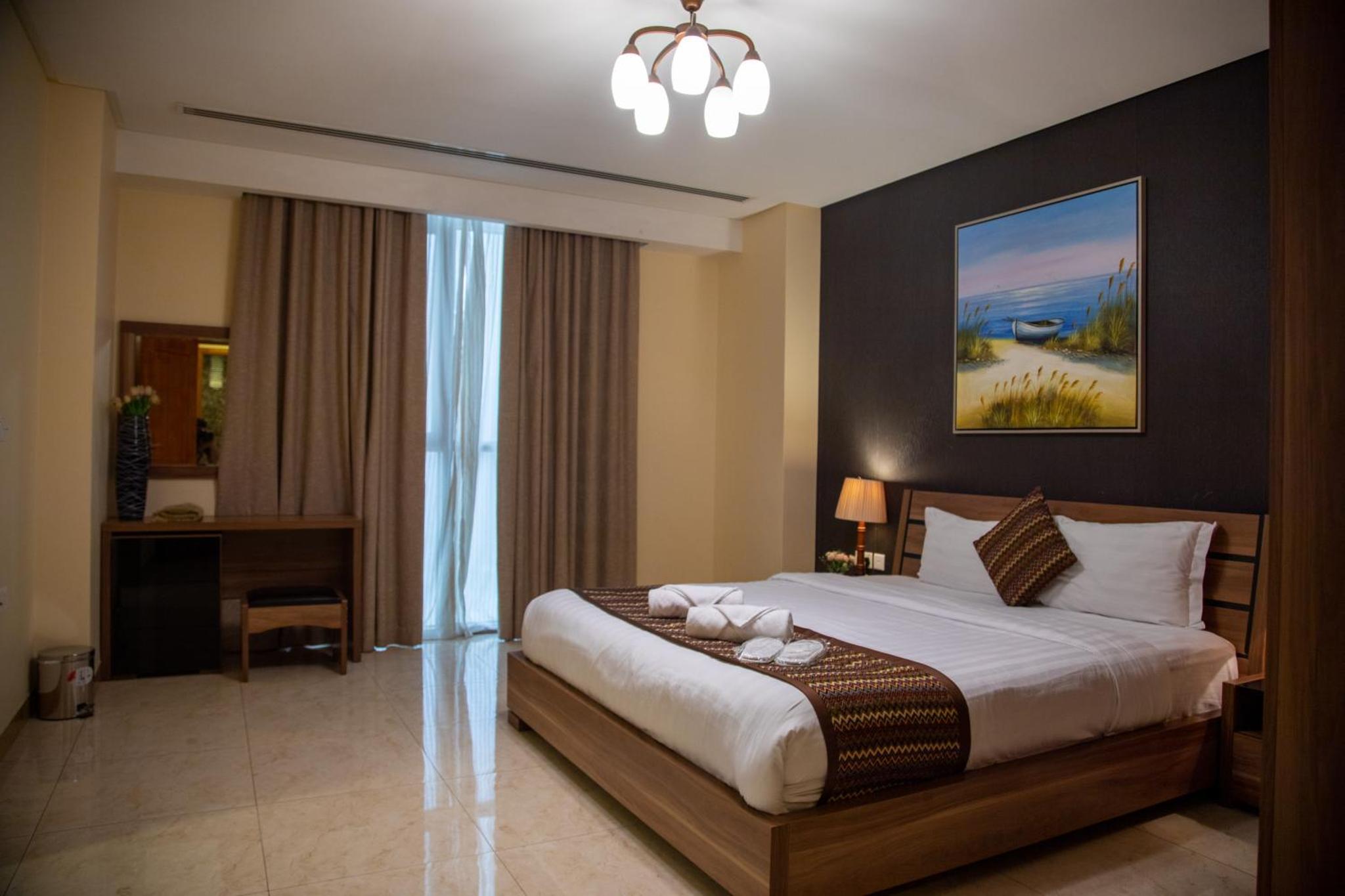 a bedroom with a large bed in a room at Juffair Trends Luxury Apartment in Juffair +42 photos