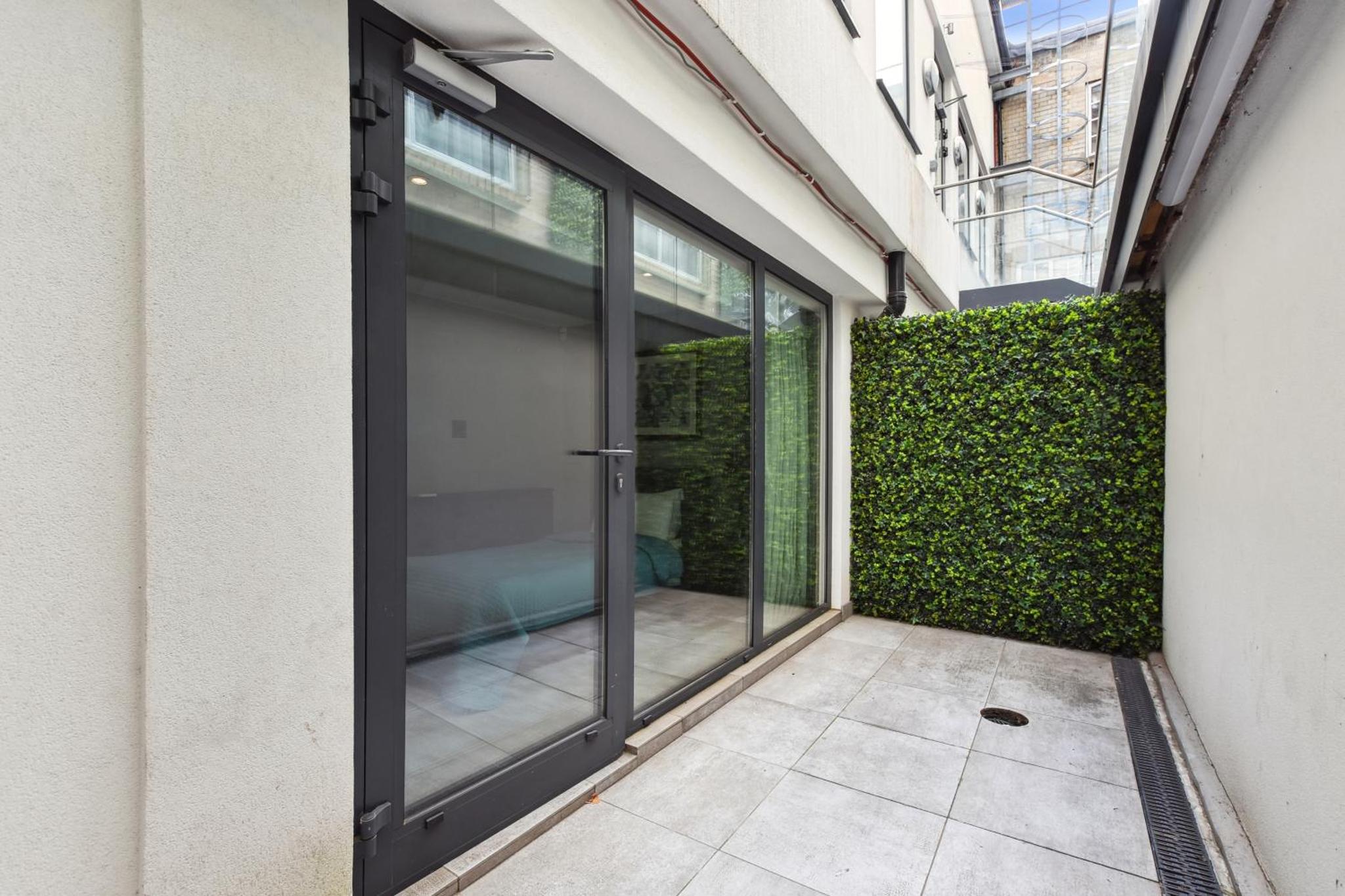 an entrance to a building with sliding glass doors at Buckingham Palace Residences by Aeria Apartments in London