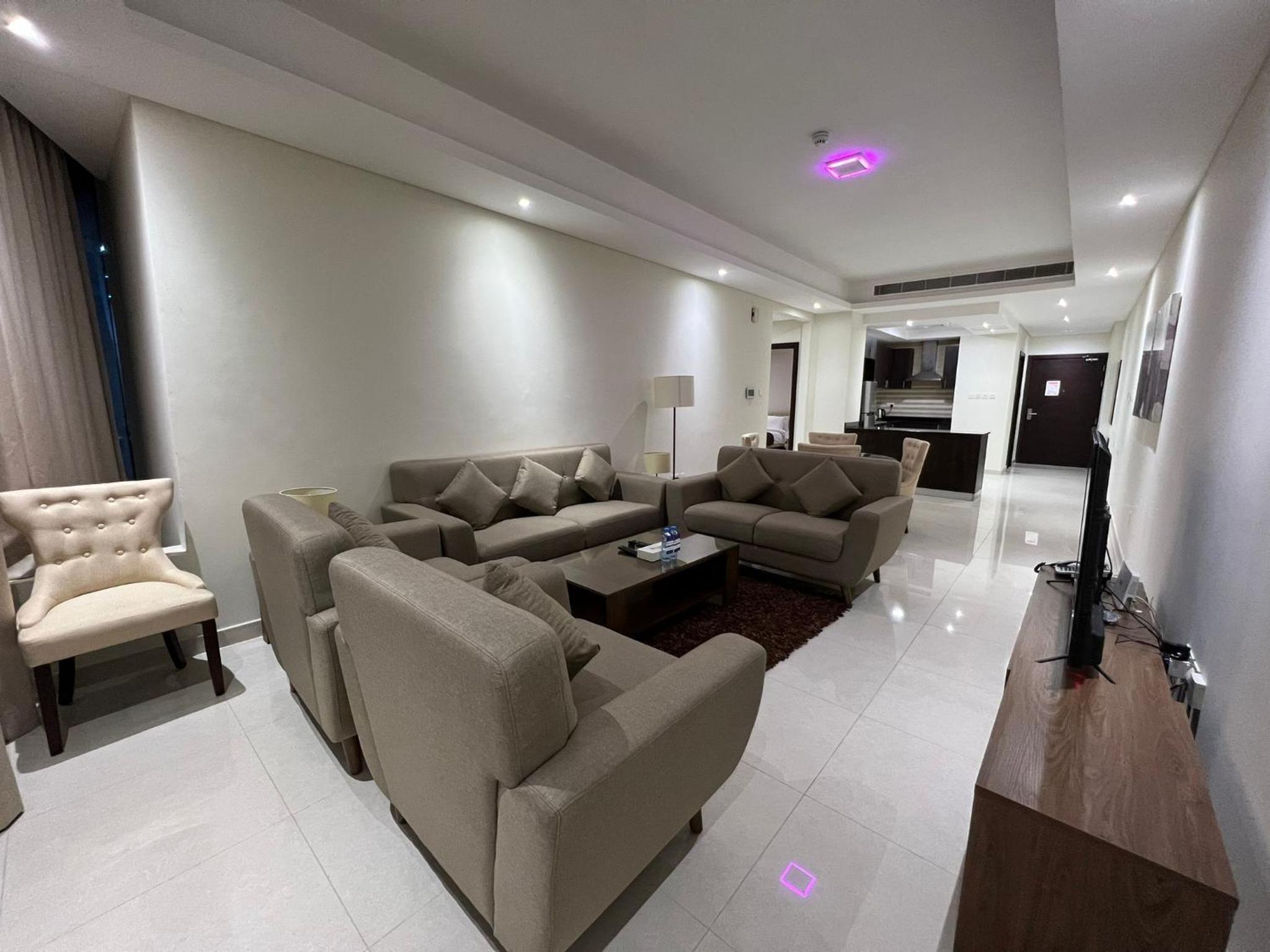 a living room with couches and a couch and a table at SIRIUS TOWER in Juffair