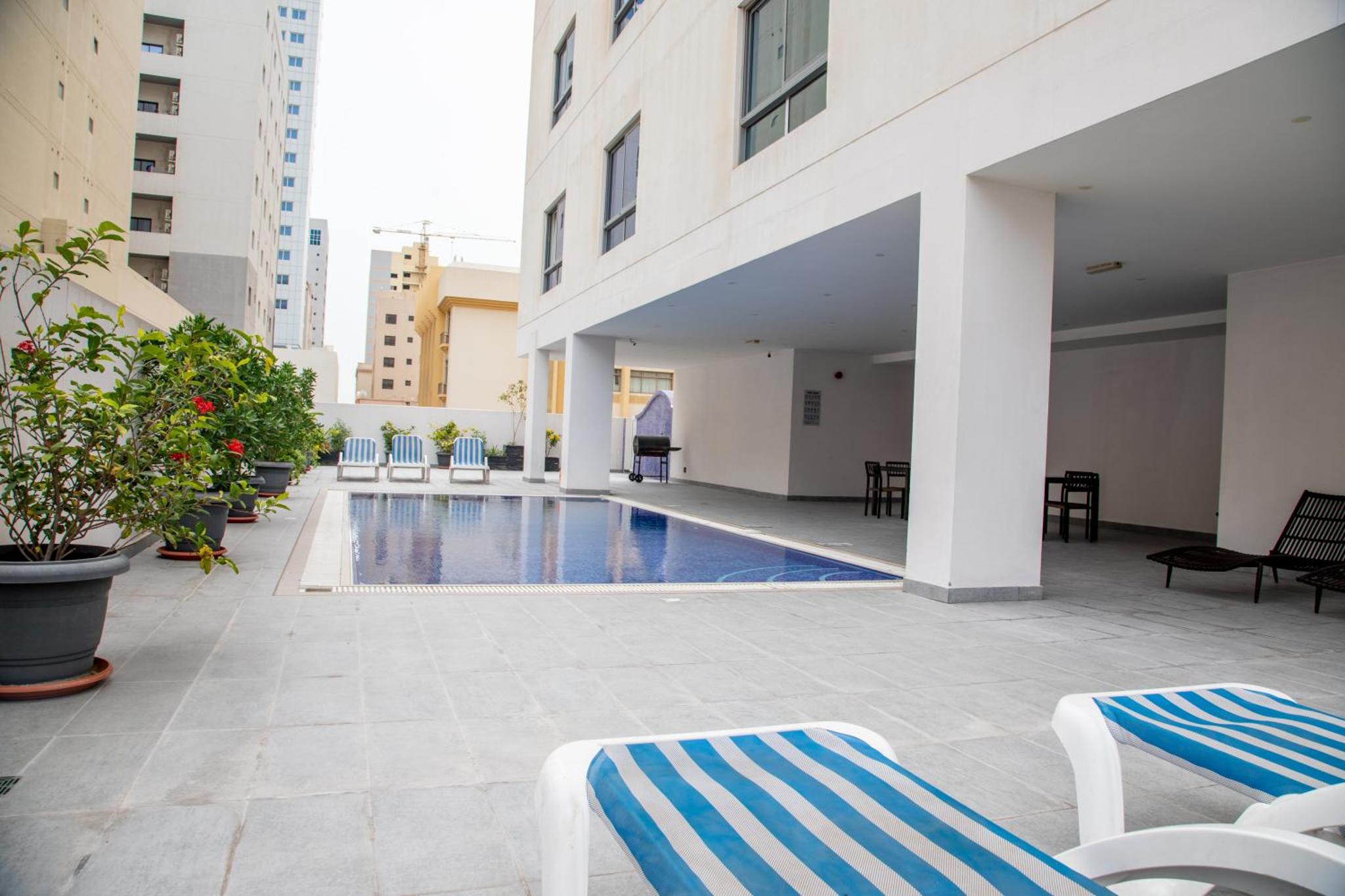 a swimming pool in the middle of a building at The Apple Residence in Juffair