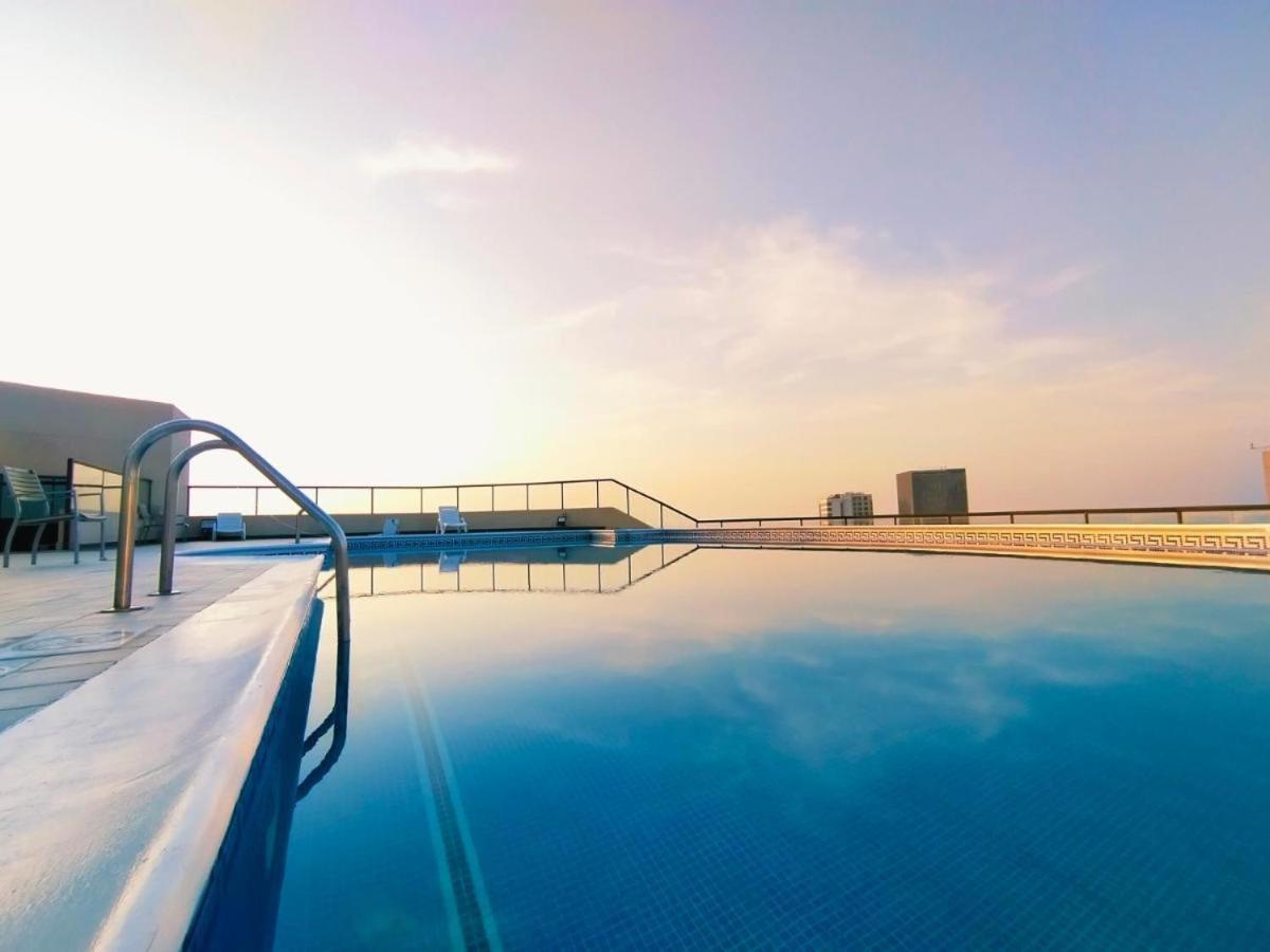 a swimming pool with a view of the horizon at seef manzil in Seef