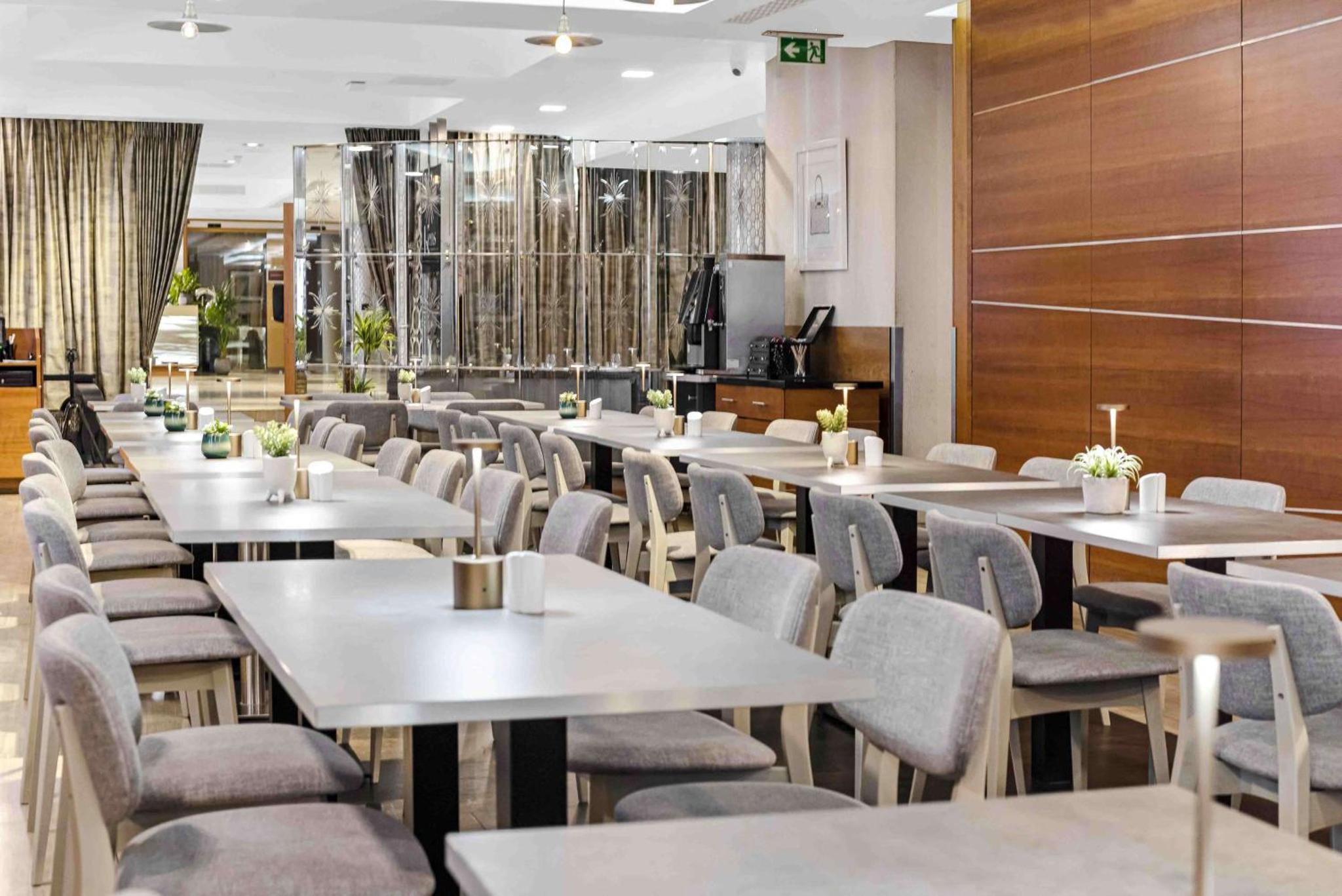 a row of tables and chairs in a restaurant at Doubletree By Hilton London Kensington in London