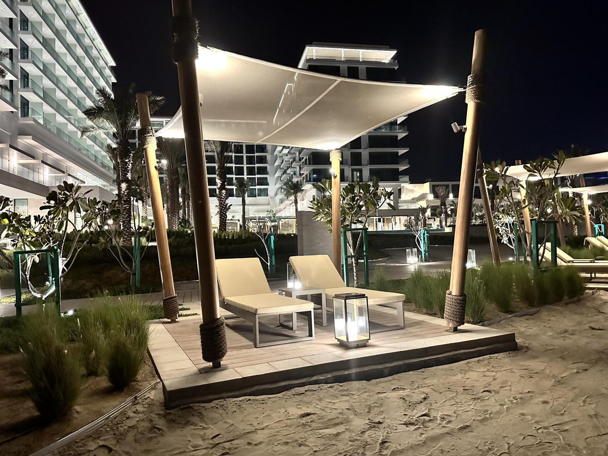 a gazebo on the beach at night at Address Beach Resort Residence Bahrain in Manama