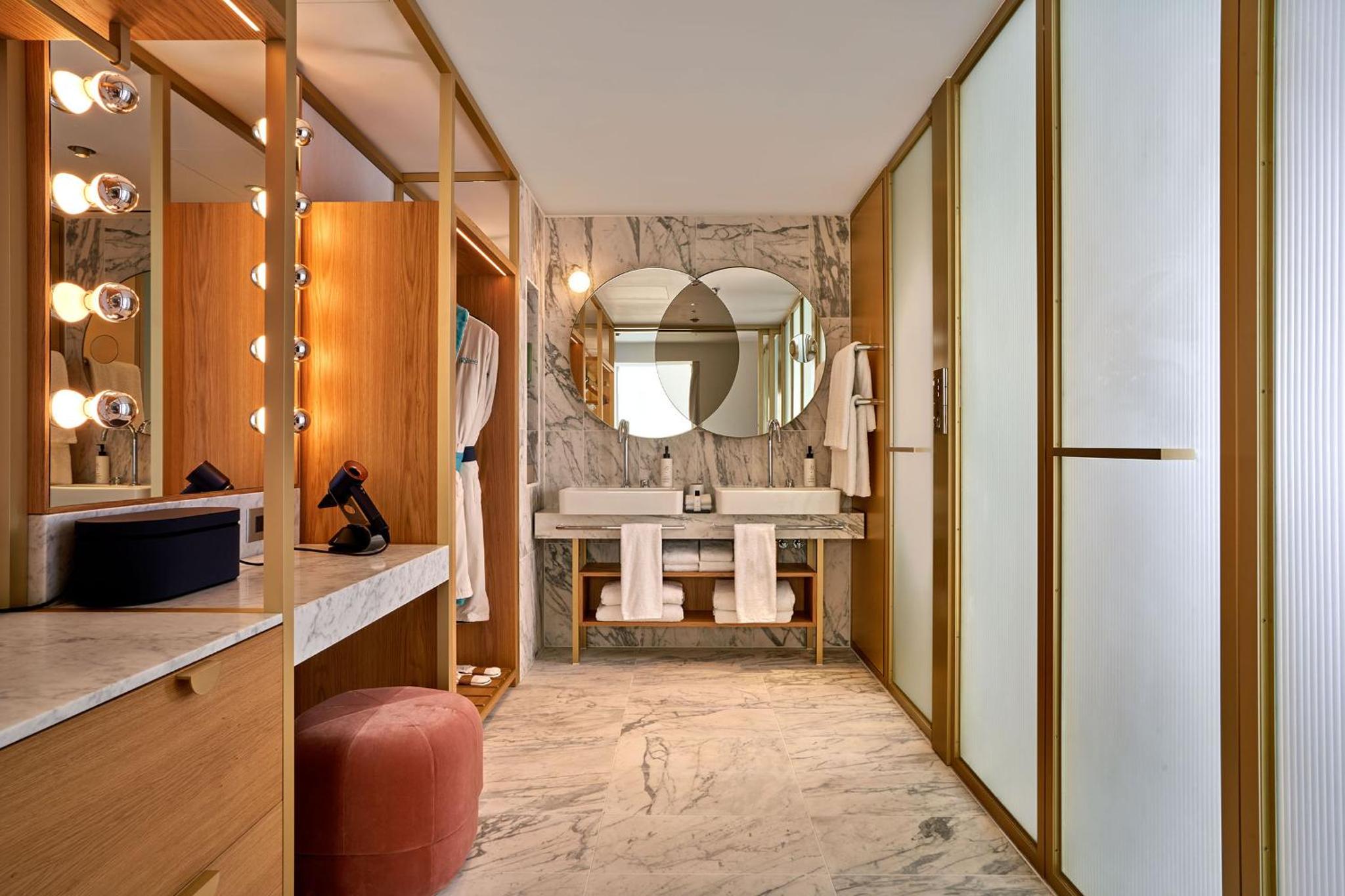a bathroom with a sink and a mirror at The BoTree London, Curio Collection by Hilton in London