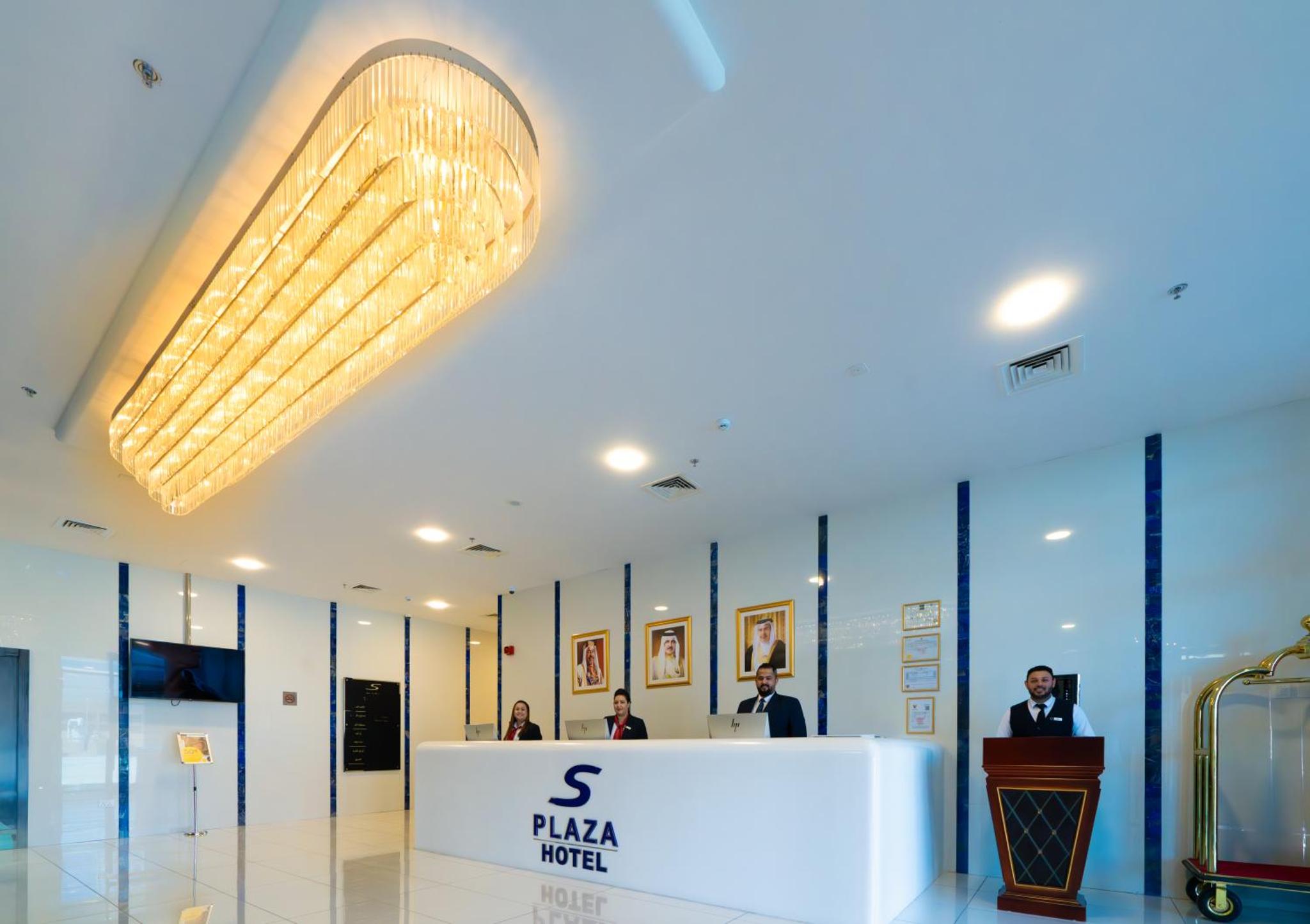 a lobby with a large chandelier in a building at S Plaza Suites Hotel in Manama +80 photos