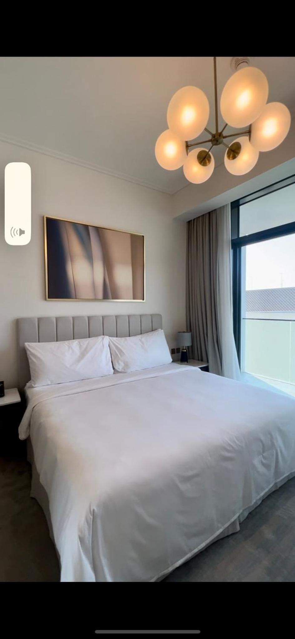 a large white bed in a bedroom with a window at شقق فندقية خاصة في منتجع العنوان الشاطئي - مراسي البحرين in Rayyā +24 photos