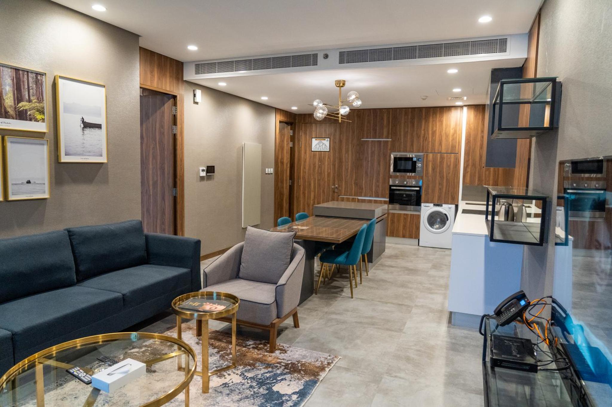 a living room with a couch and a table at Modern Heights in Juffair