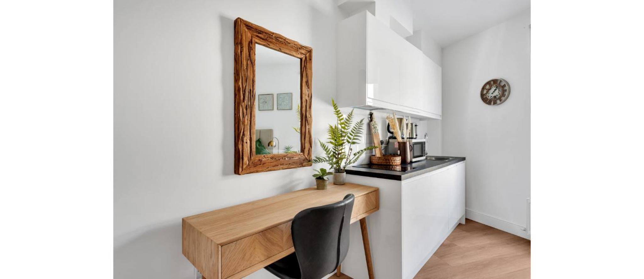 a mirror on a wall above a desk in a room at Cozy and Lovely Studio - Close to everything! in London