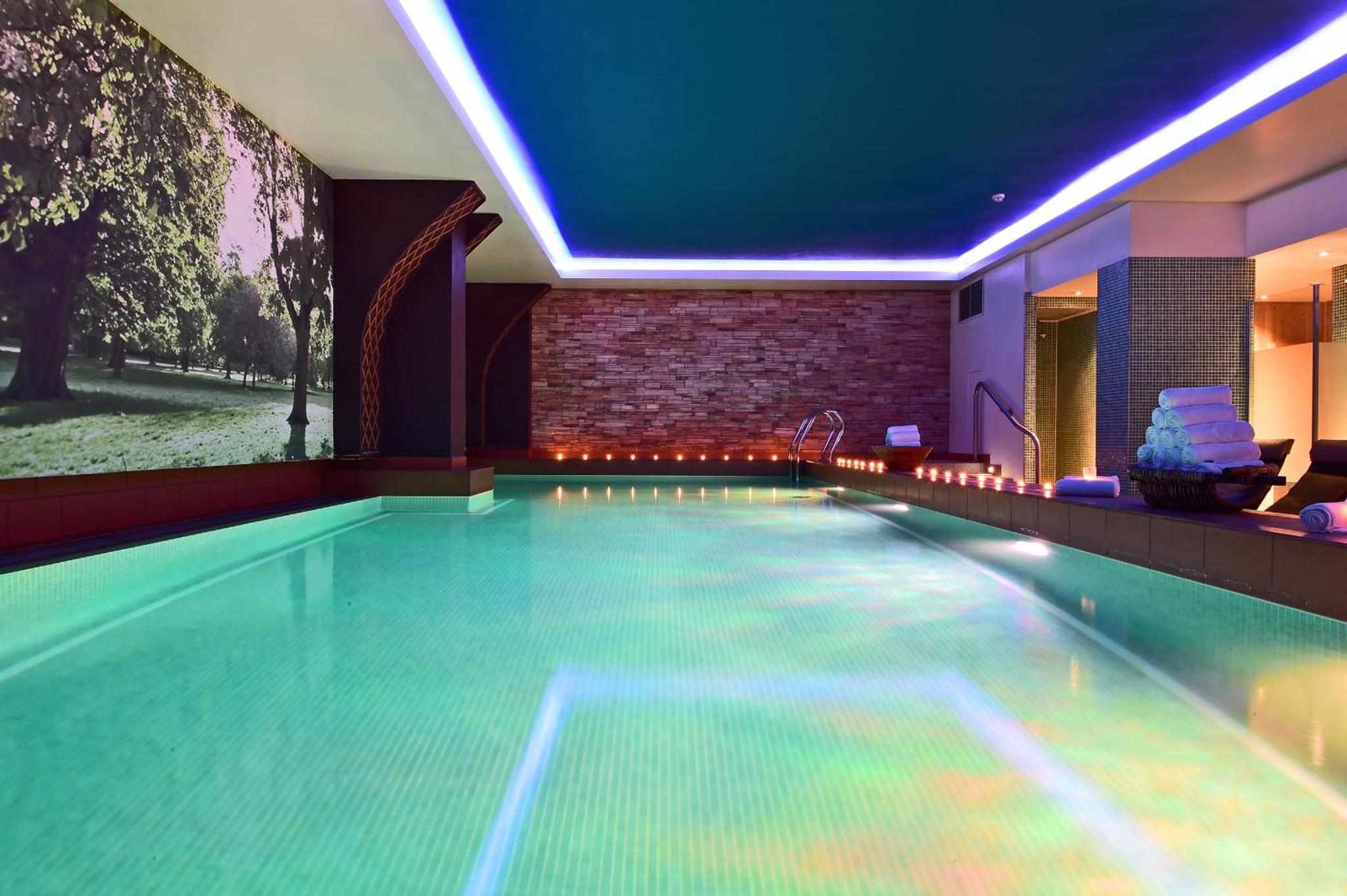 a swimming pool in a hotel room with a swimming pool at Pestana Chelsea Bridge Hotel & SPA in London
