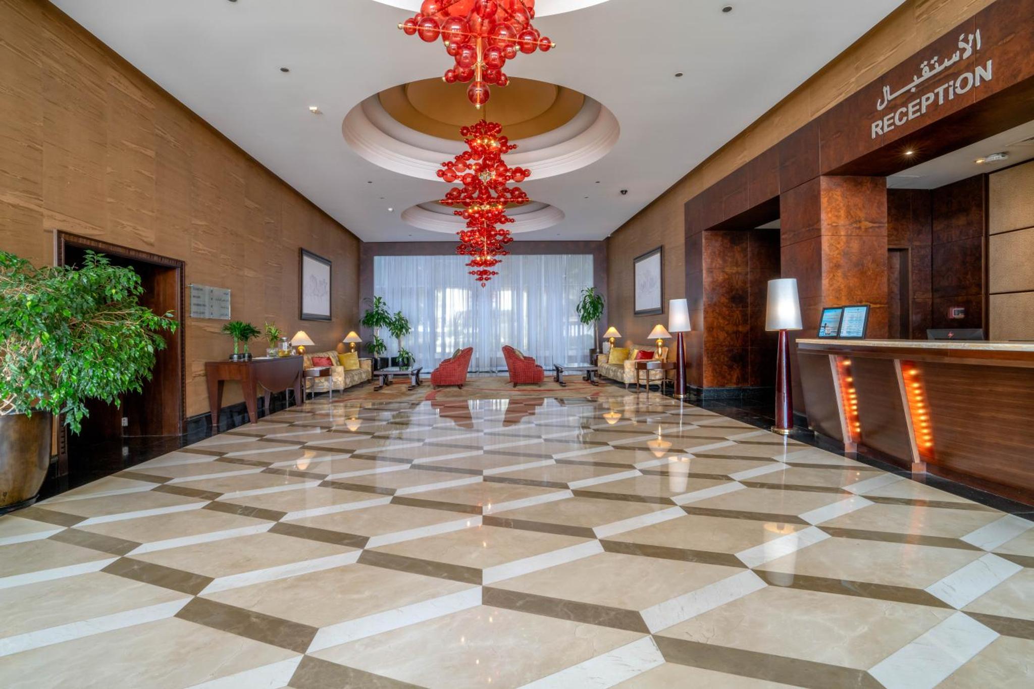 a lobby of a hotel with a checkered floor at The Diplomat Radisson Blu Residence in Manama +49 photos