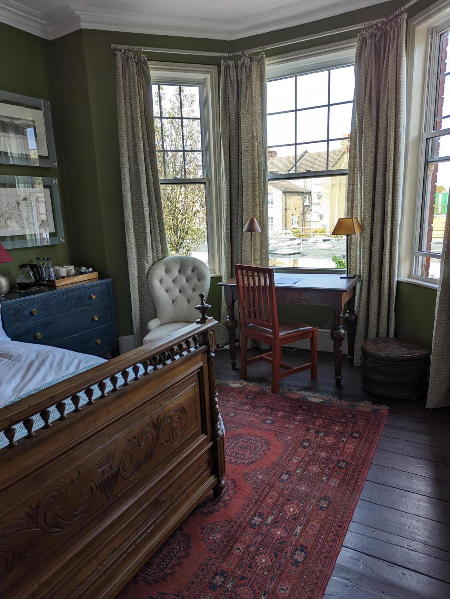 a bedroom with a bed and a desk and a chair at Trent Rd in London +5 photos