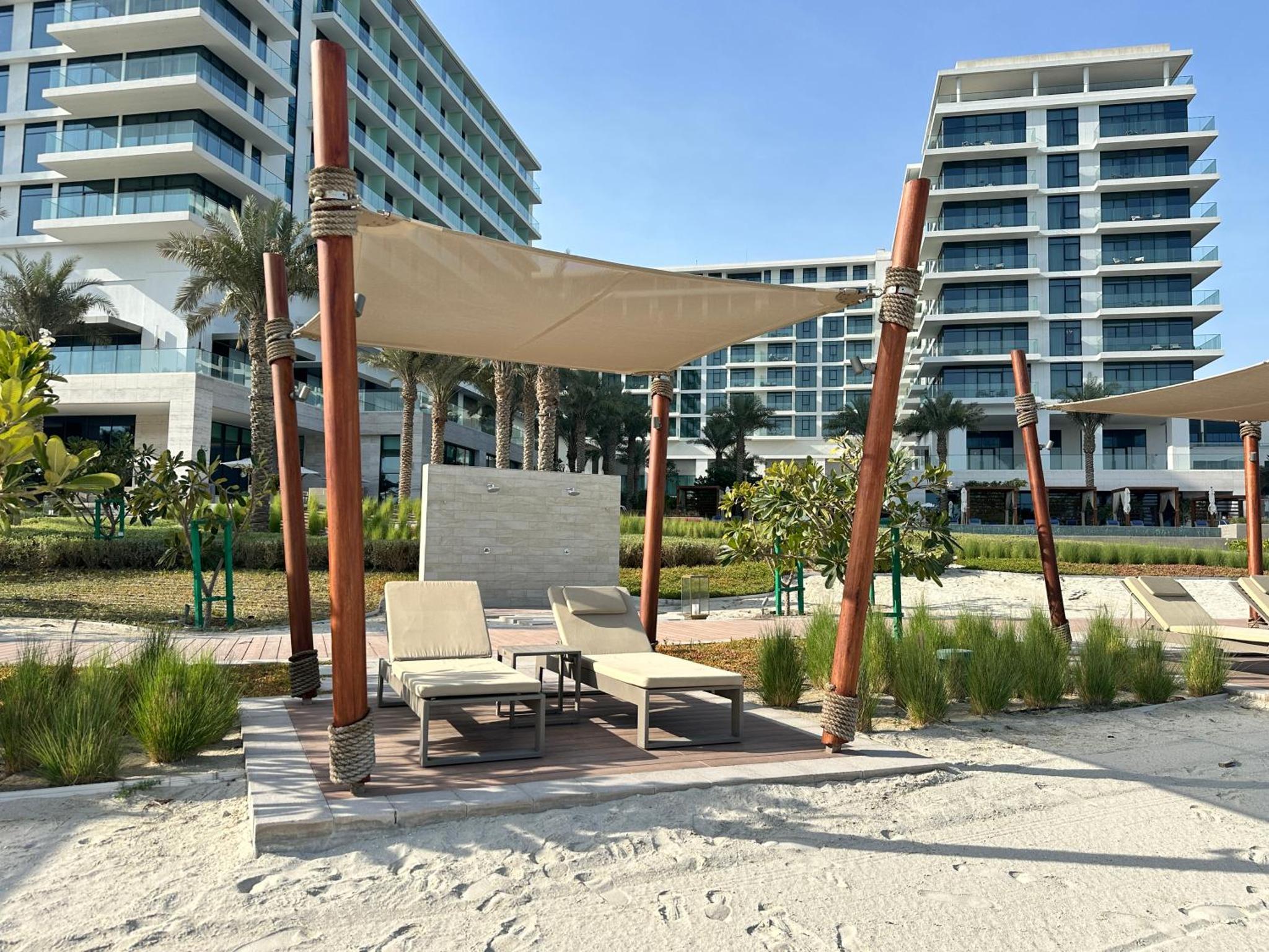 a gazebo with chairs and a table on the beach at Address Beach Resort Residence Bahrain in Manama +139 photos