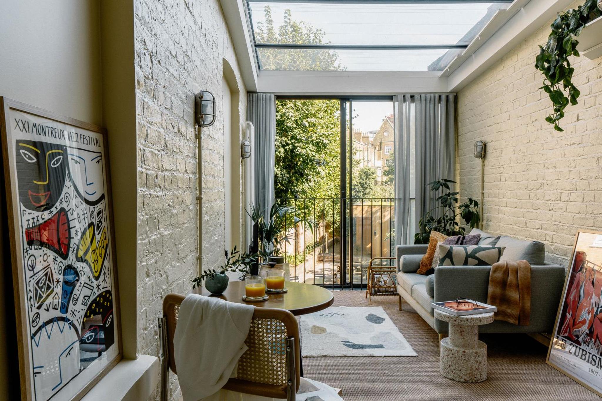 a living room with a couch and a table at Mason & Fifth, Primrose Hill in London