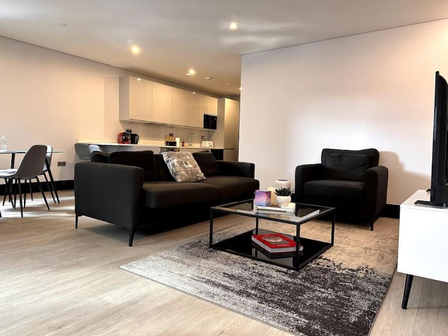 a living room with a couch and a table at The Glamour of Shoreditch in London