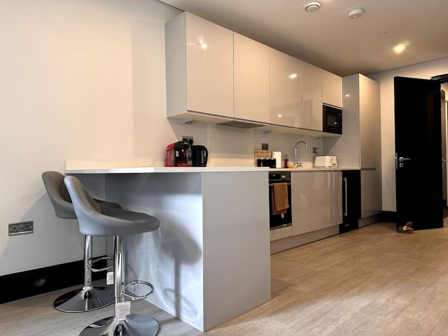 a kitchen with a counter and a chair in a room at The Glamour of Shoreditch in London +19 photos