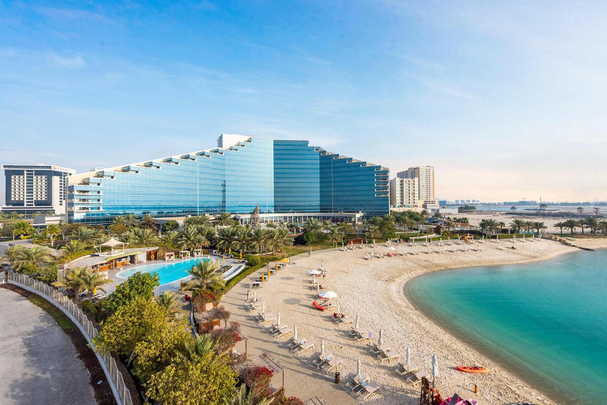 a view of a hotel and a beach with the ocean at The Art Hotel & Resort in Manama
