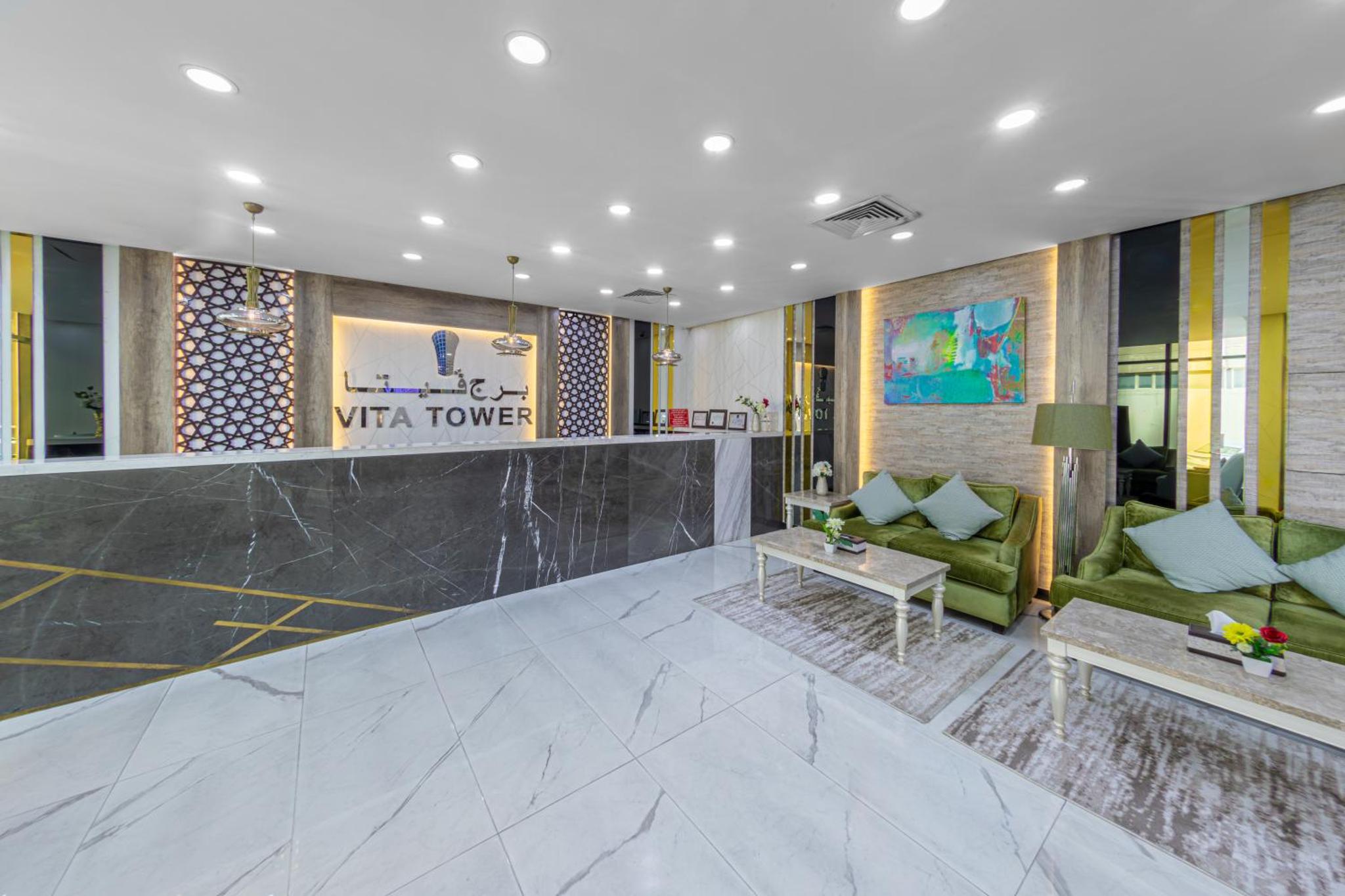 a lobby of a hotel with a couch and a table at Vita Tower in Manama +100 photos