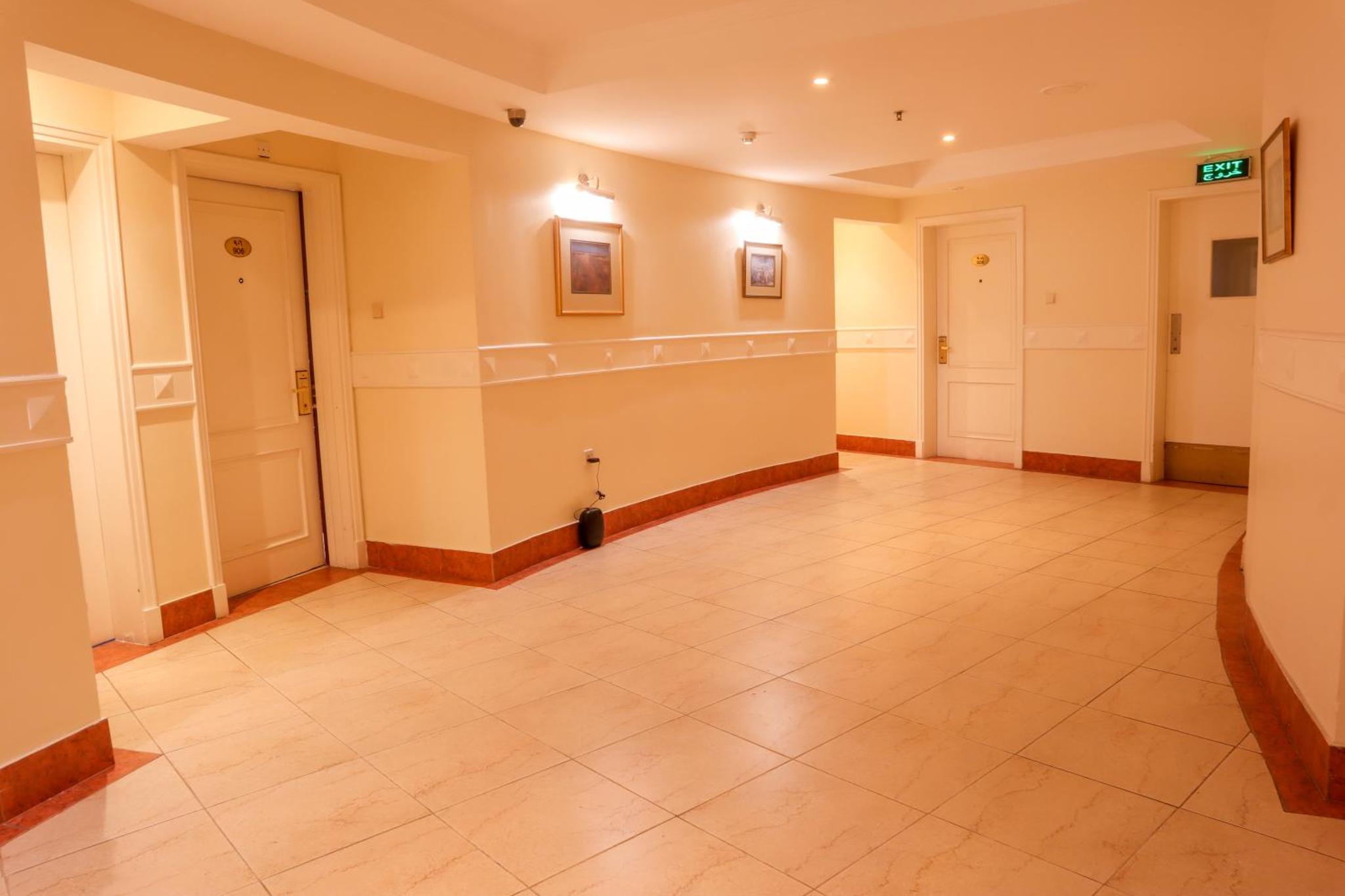 a large room with a tile floor and a hallway at Palette Luxury Marina View Formerly Happy Days Hotel in Manama +22 photos