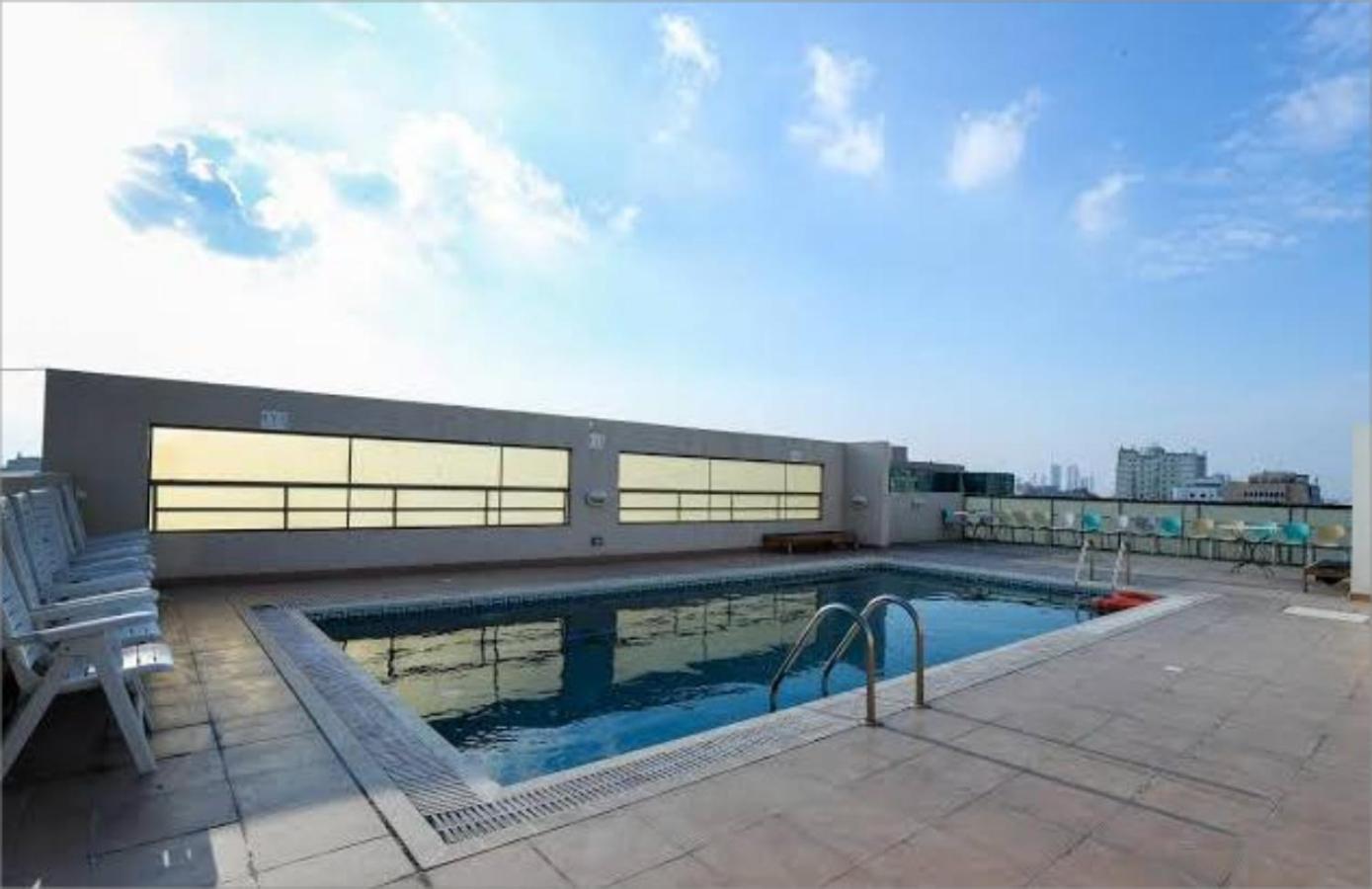 a swimming pool on the roof of a building at Infinity Tower Suites WLL in Manama