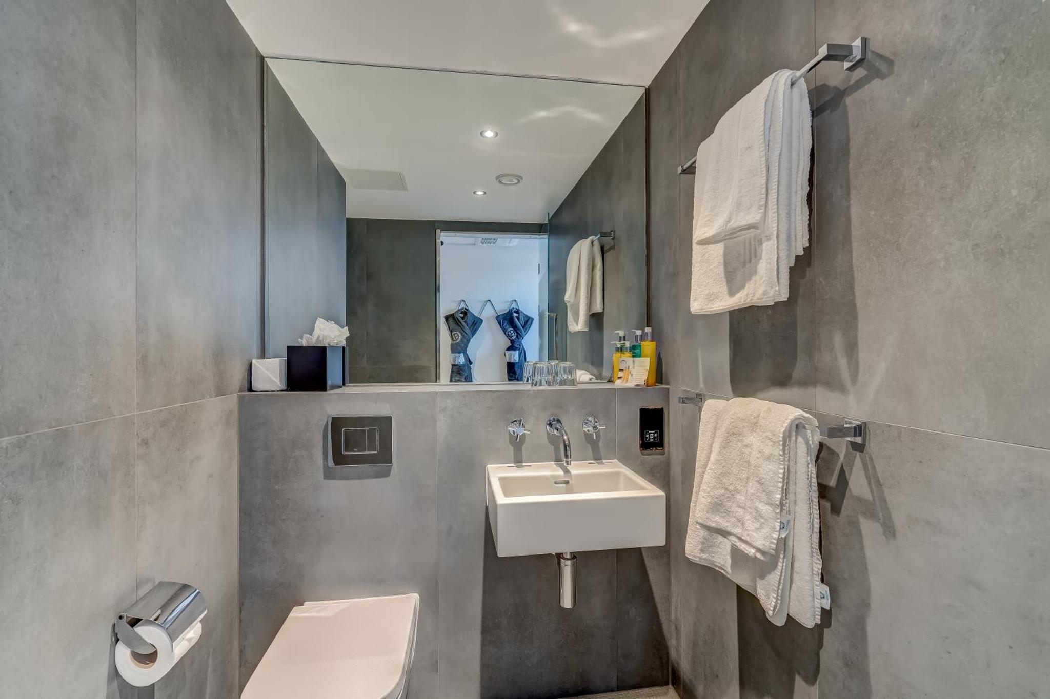a bathroom with a sink and a toilet at New Road Hotel in London