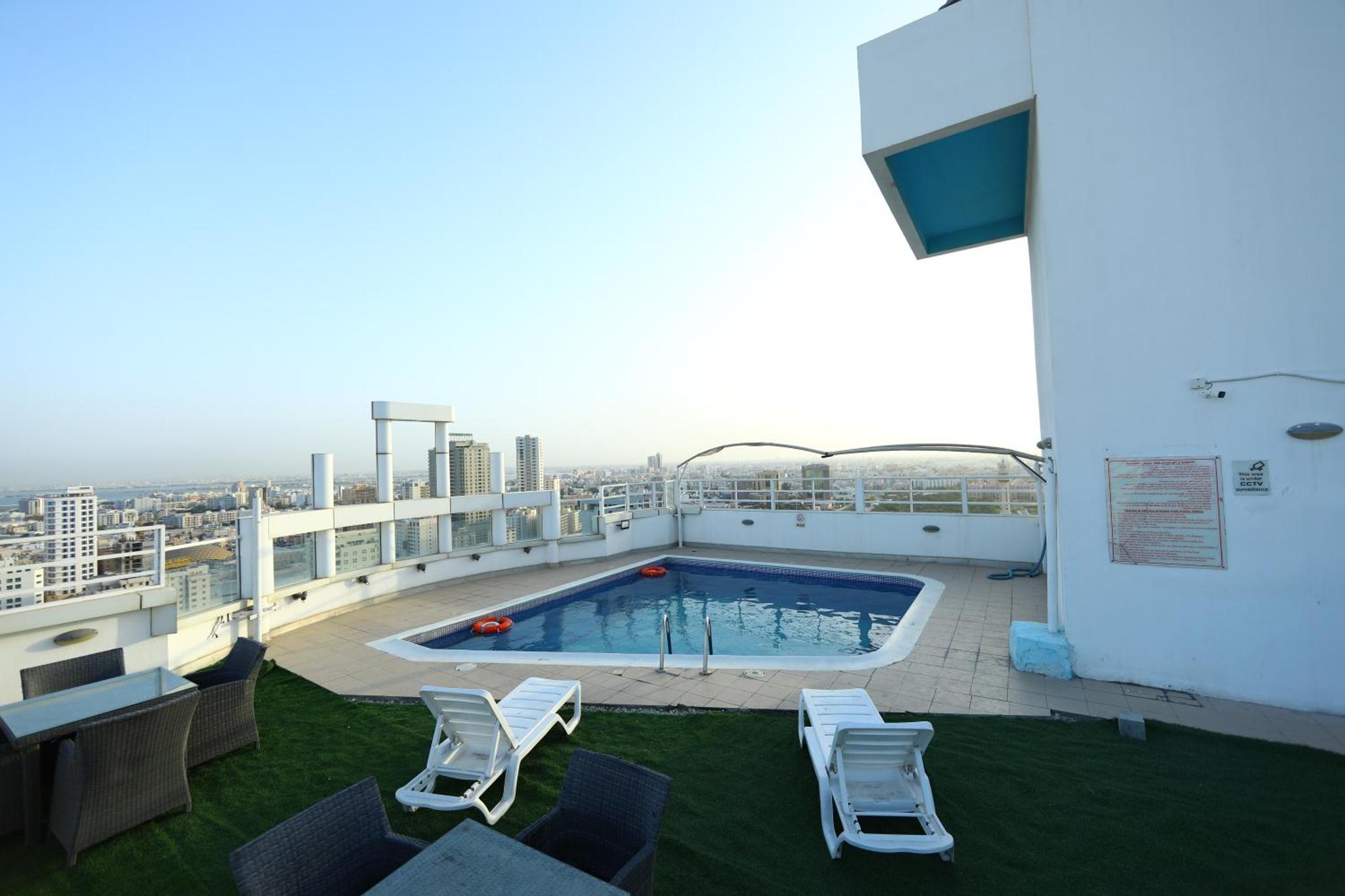 a balcony with a swimming pool on top of a building at Landway Suite in Manama