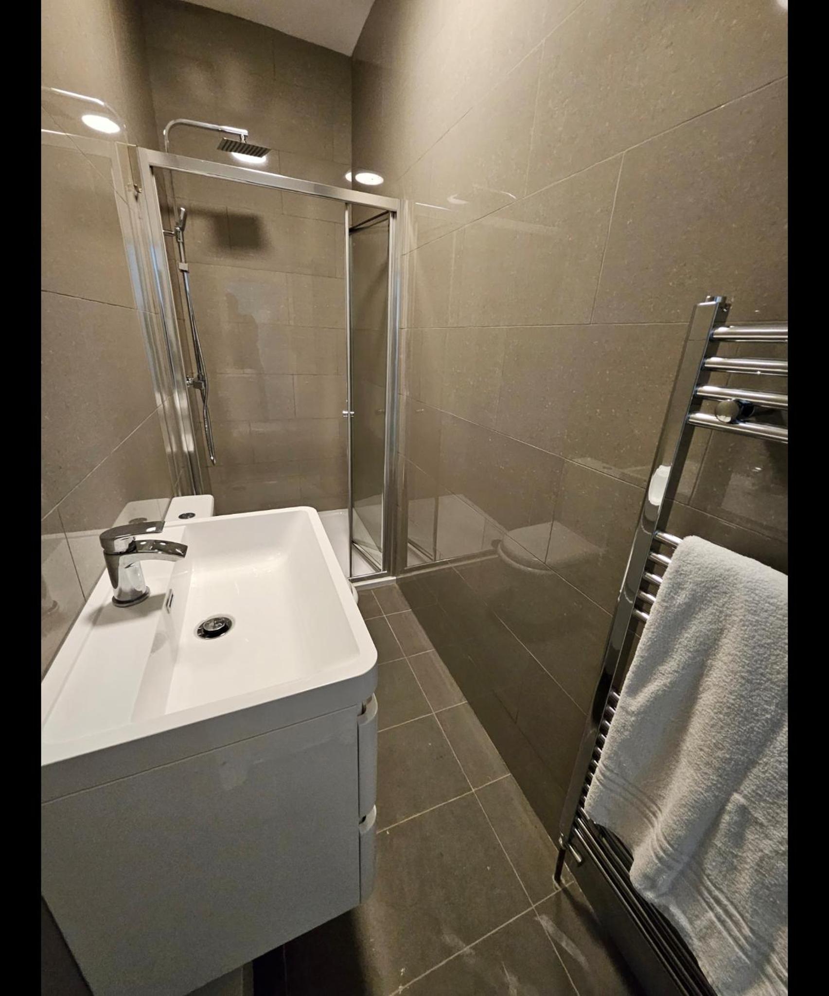 a bathroom with a sink and a shower at Mia residence, Waterloo 4bed Room Apa in London