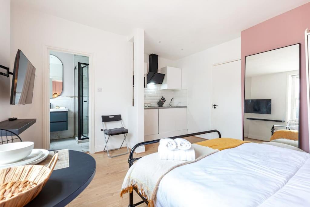 a bedroom with a bed with two towels on it at Beautiful Studio in Bayswater in London