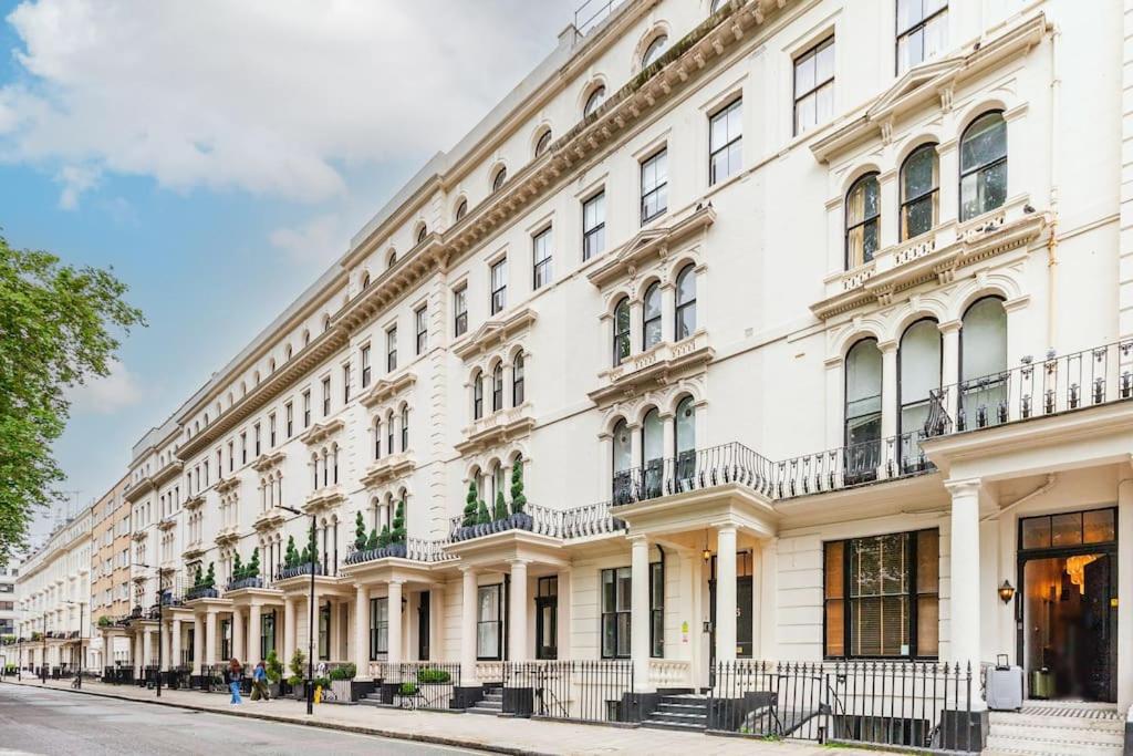 a large white building on a street at Beautiful Studio in Bayswater in London