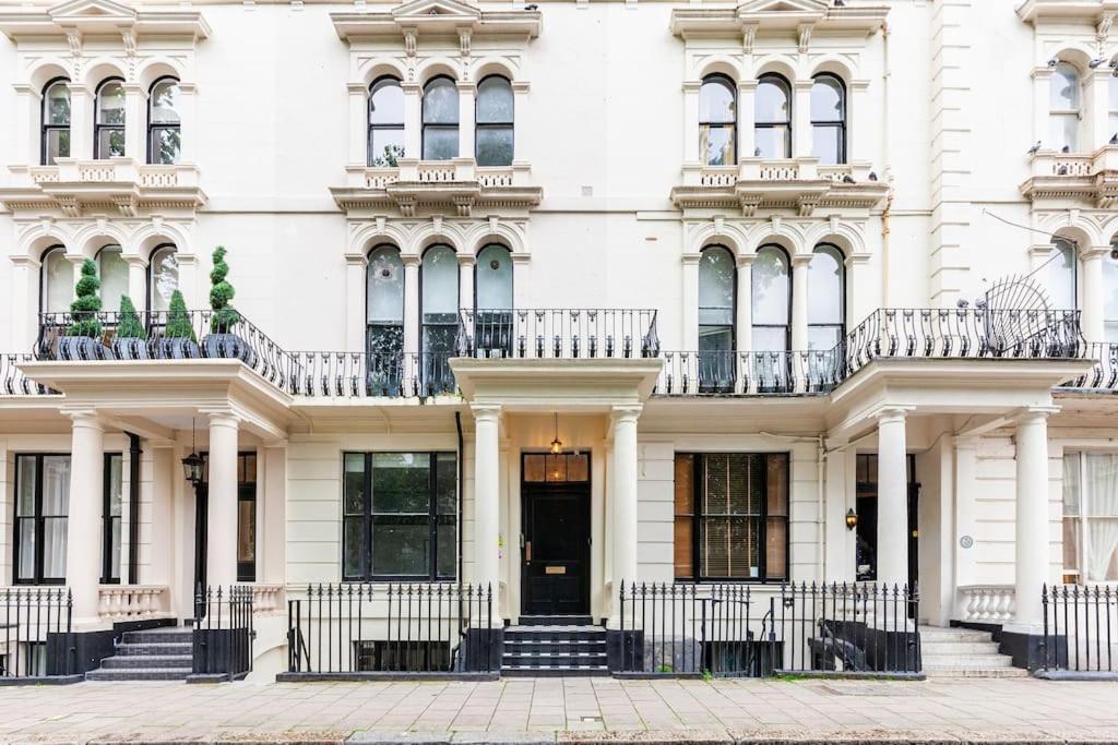 a white building with stairs and a door at Beautiful Studio in Bayswater in London +11 photos