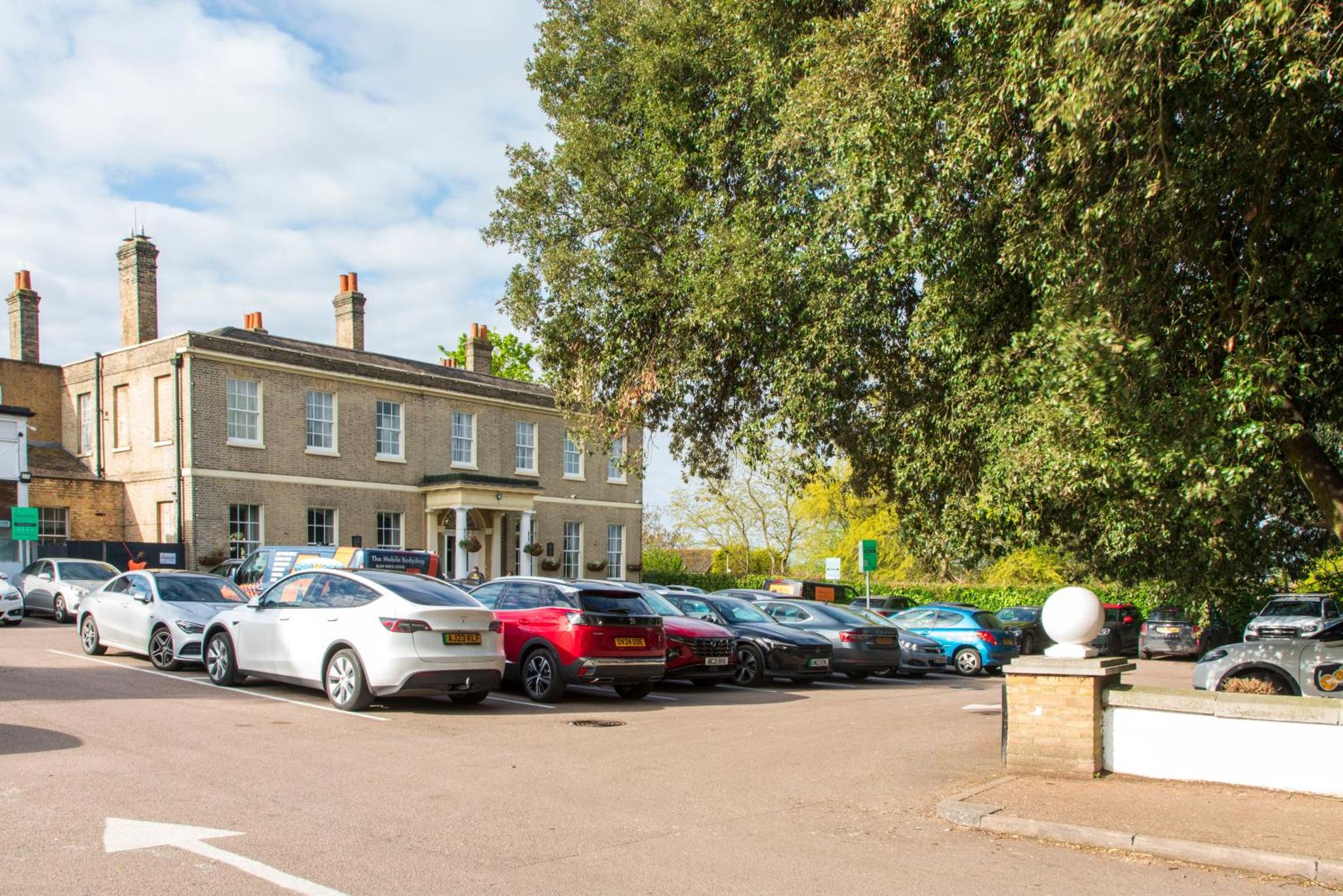 a row of cars parked in a parking lot at London Chigwell Prince Regent Hotel, BW Signature Collection in London +65 photos