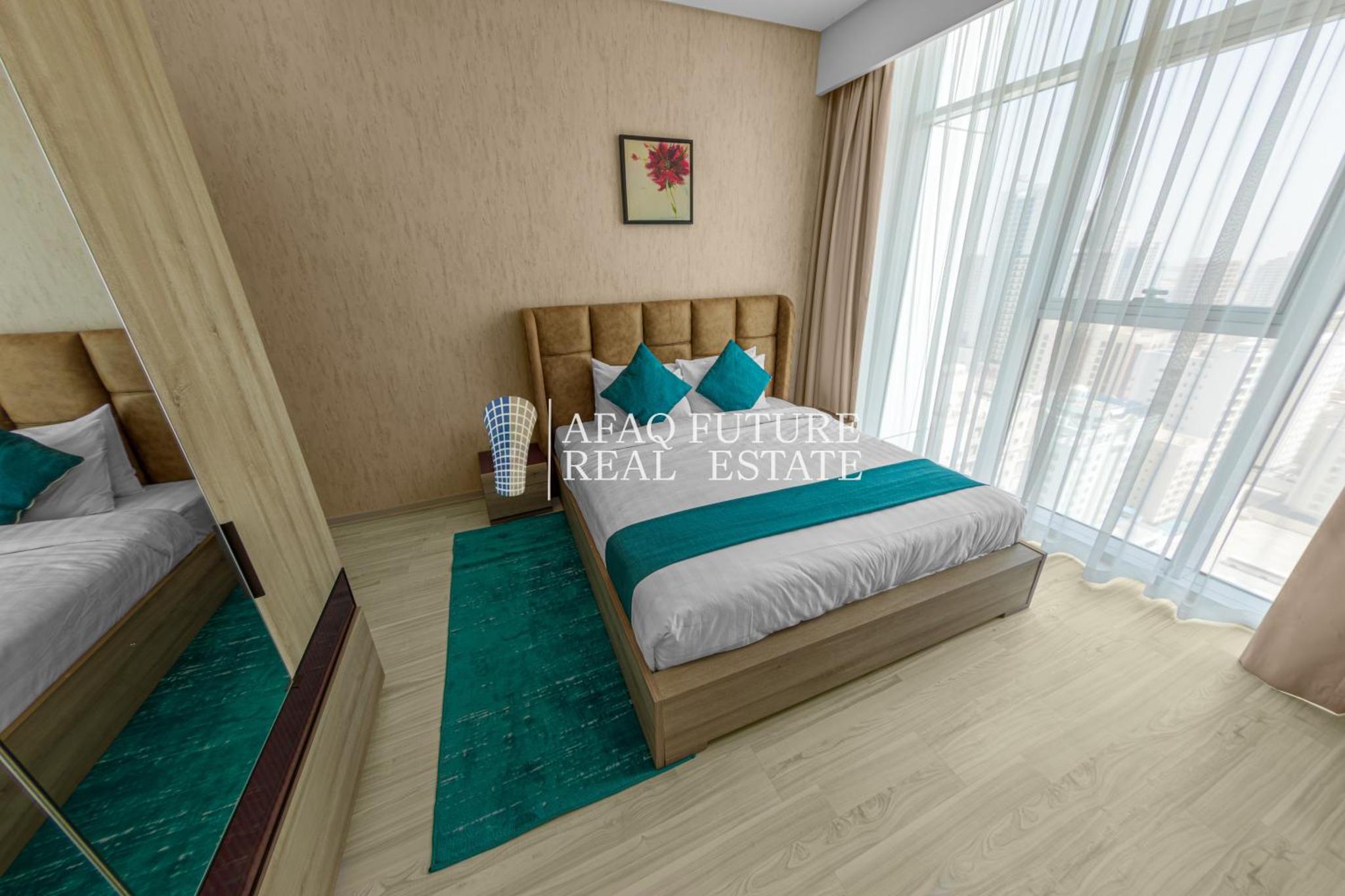 a bedroom with a bed and a large window at Vita Suites in Manama +67 photos