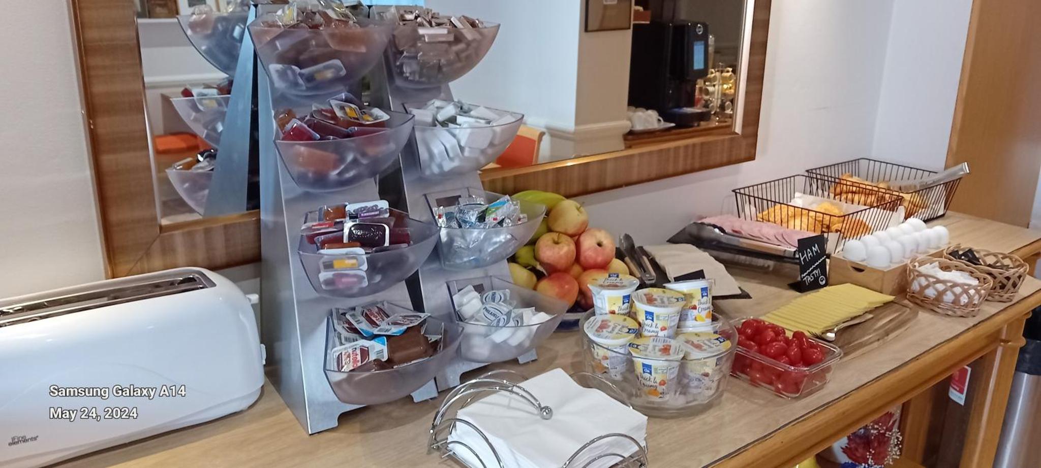 a counter with a bunch of fruit and other food at Americana Hotel in London +22 photos