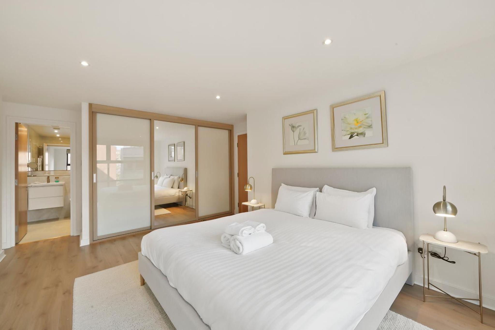a bedroom with a white bed with a towel on it at Flat 315, 33 Birtton Street in London