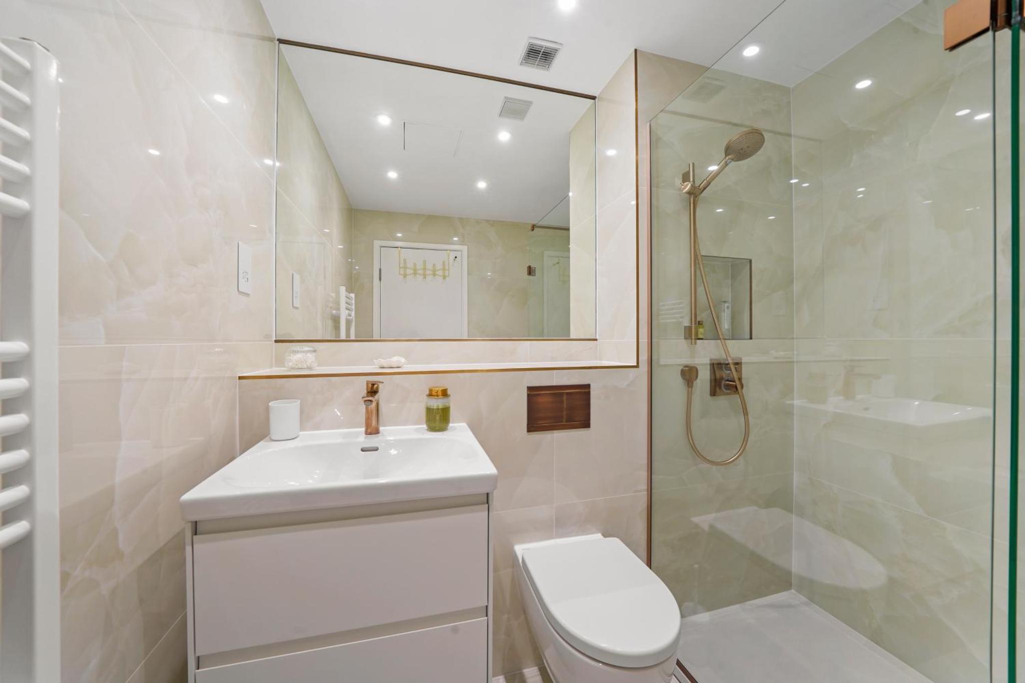 a bathroom with a toilet and a shower and a sink at Flat 315, 33 Birtton Street in London