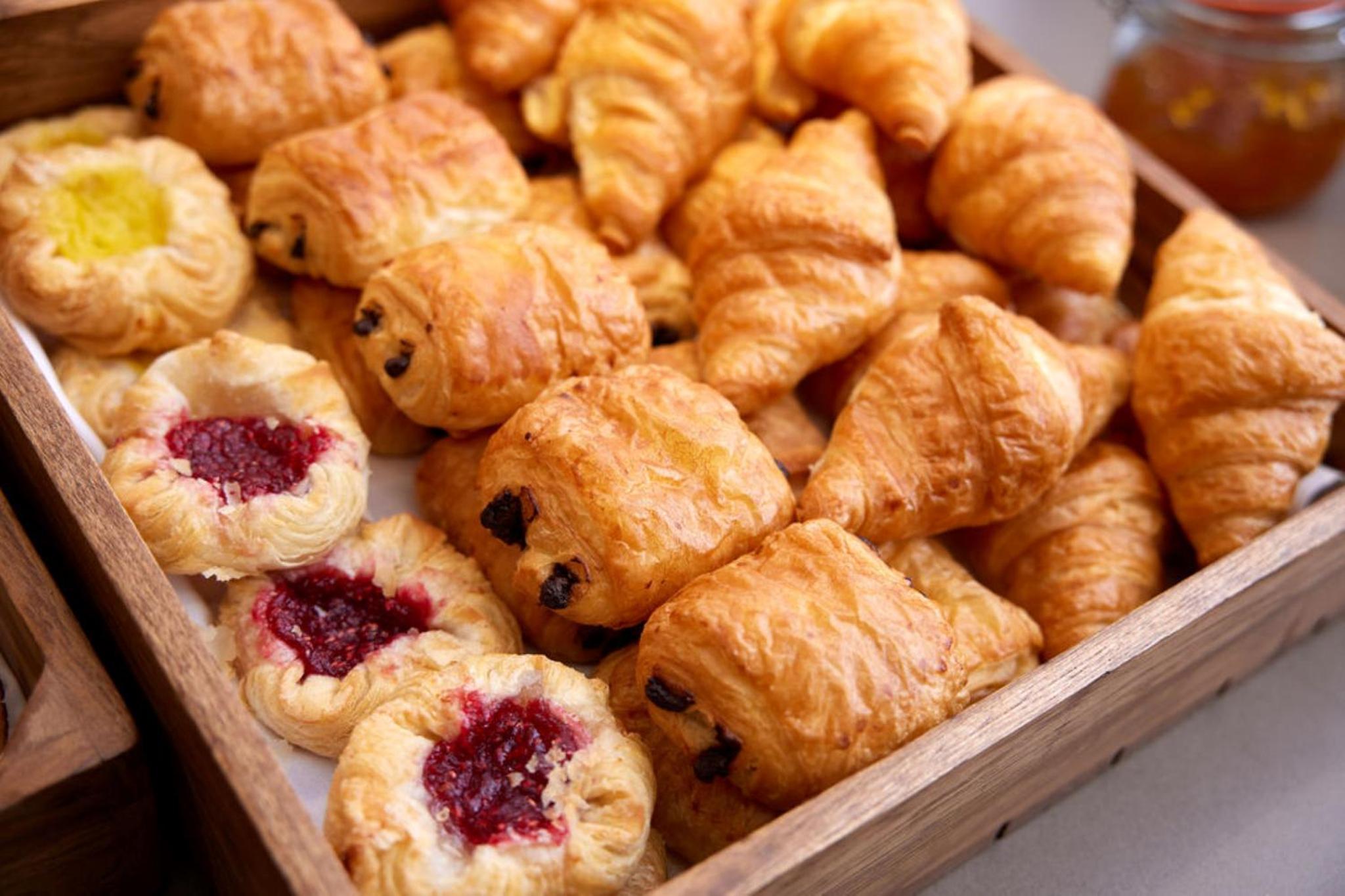 a box filled with croissants and other pastries at Thistle London Piccadilly in London +19 photos