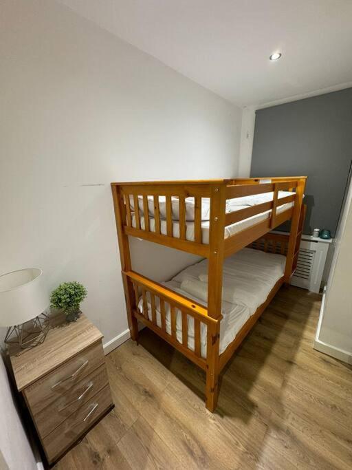 two bunk beds in a room with a lamp at Sleep 6 - 5 min from Camden Market HW5 in London +6 photos