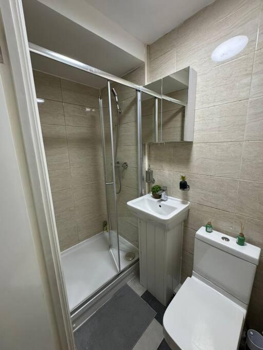 a bathroom with a shower and a toilet and a sink at Sleep 6 - 5 min from Camden Market HW5 in London