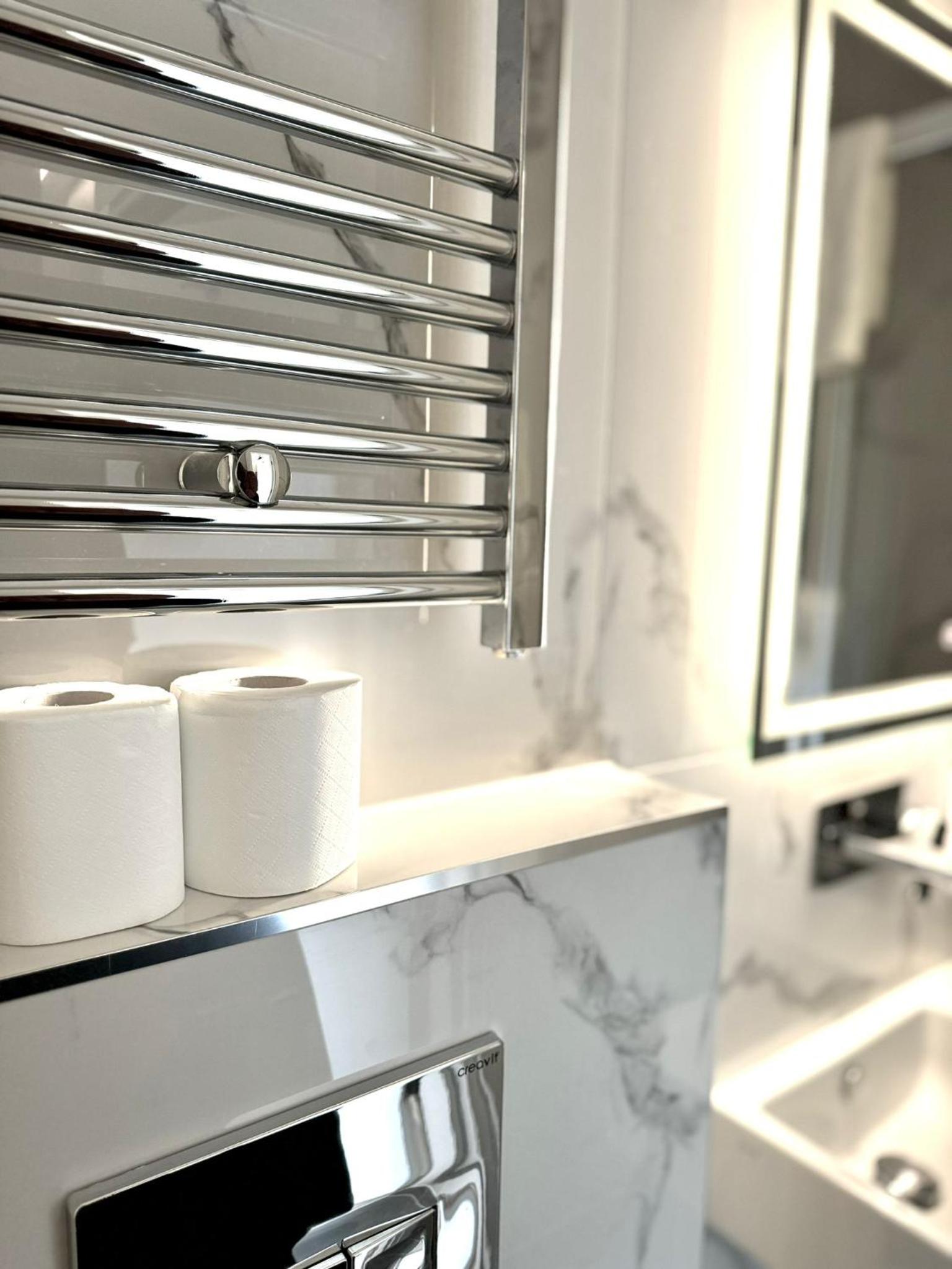 a bathroom with two rolls of toilet paper on a counter at Victoria Studios in London +77 photos