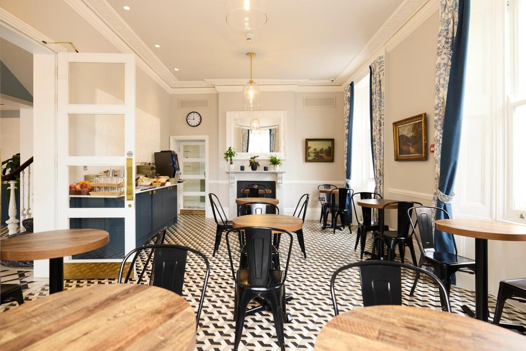 a restaurant with tables and chairs in a room at Prince William Hotel in London +27 photos