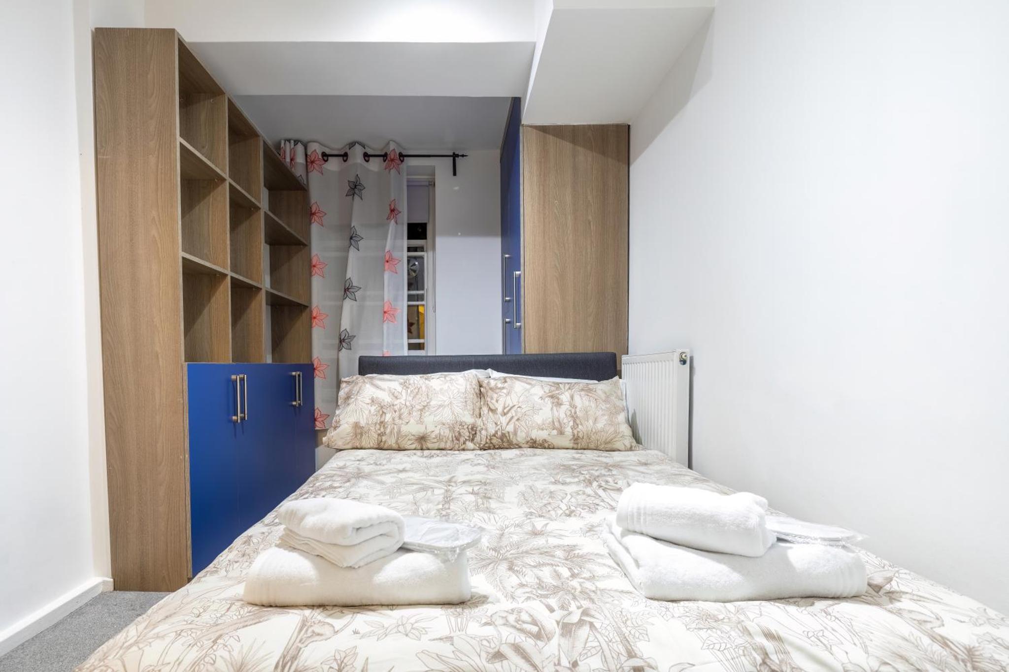 a bedroom with a bed with two towels on it at Quiet location in central London, close to Paddington, Regent Park, Lord's Cricket, late check-in in London