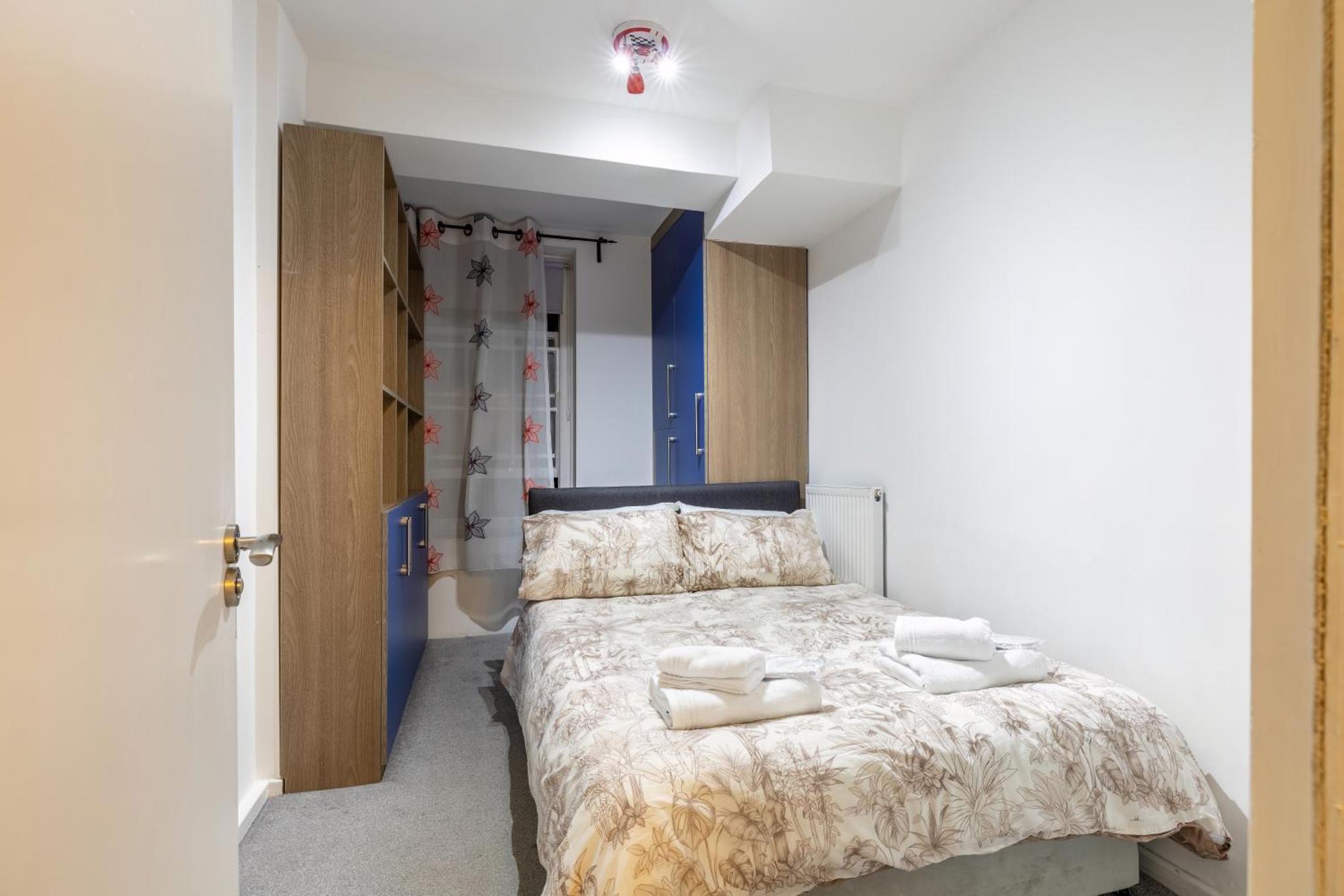 a bedroom with a bed with towels on it at Quiet location in central London, close to Paddington, Regent Park, Lord's Cricket, late check-in in London
