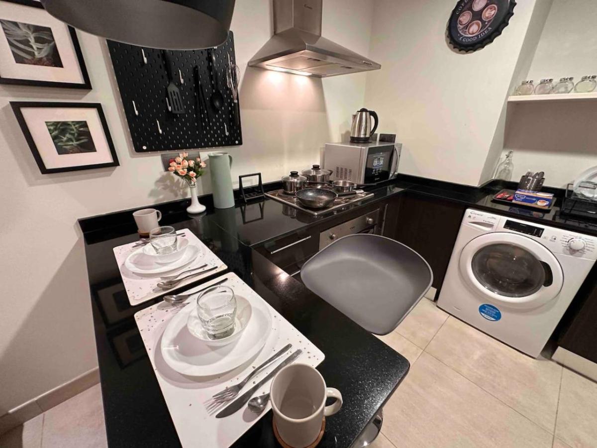 a kitchen with a sink and a washing machine at High Floor Era View Tower City View in Manama