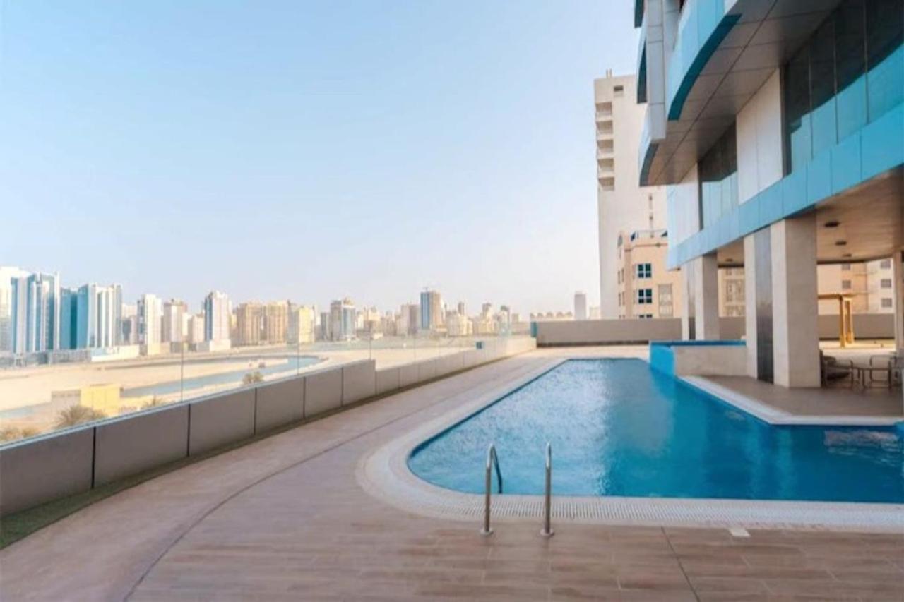 a swimming pool on the roof of a building at High Floor Era View Tower City View in Manama