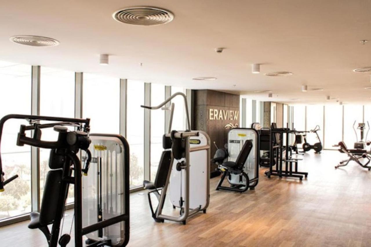 a gym with treadmills and exercise equipment in a building at High Floor Era View Tower City View in Manama